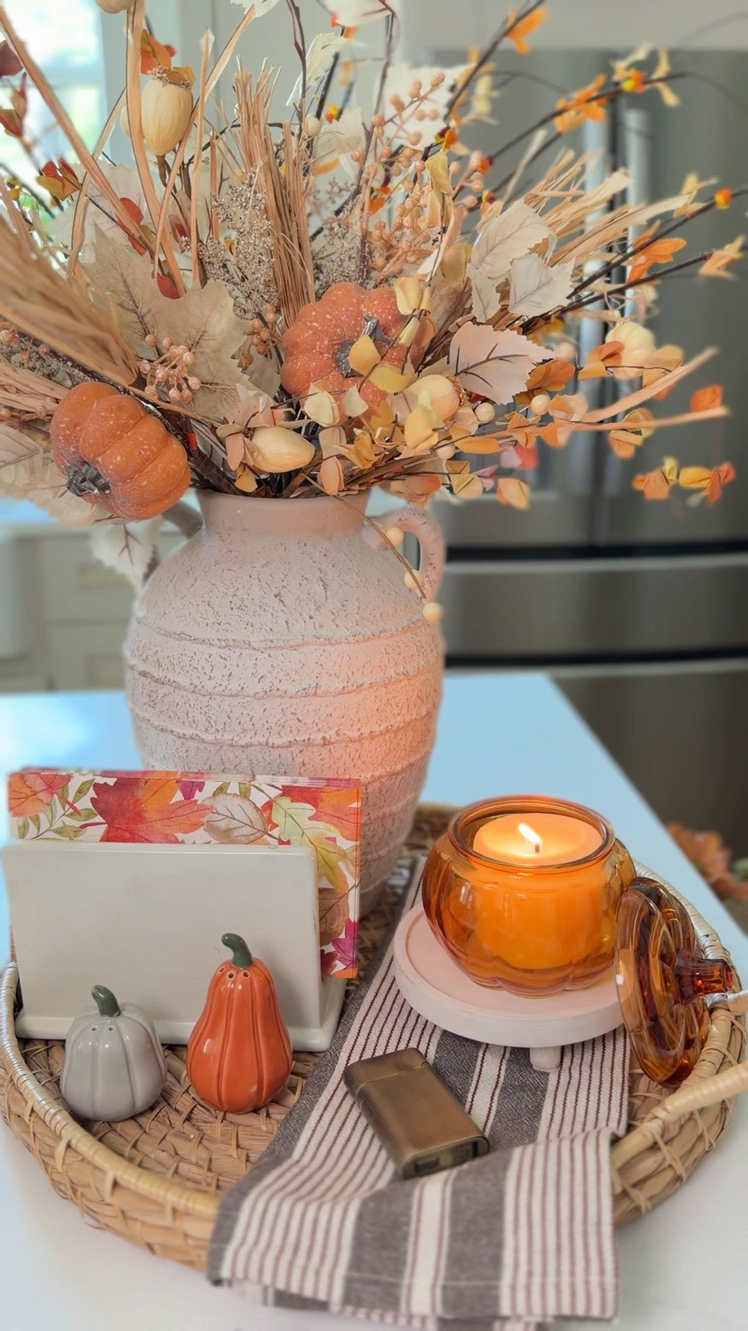 Easy fall tray styling for September 🍂 If you’re looking for simple, affordable ways to make your kitchen feel cozy for fall, this is such an easy one! A woven tray, textured vase, fall stems, mini pumpkins and a cozy candle completely change the space. I linked everything I could find + similar options so you can recreate the look. 🤎🎃

#LTKHome #LTKSeasonal