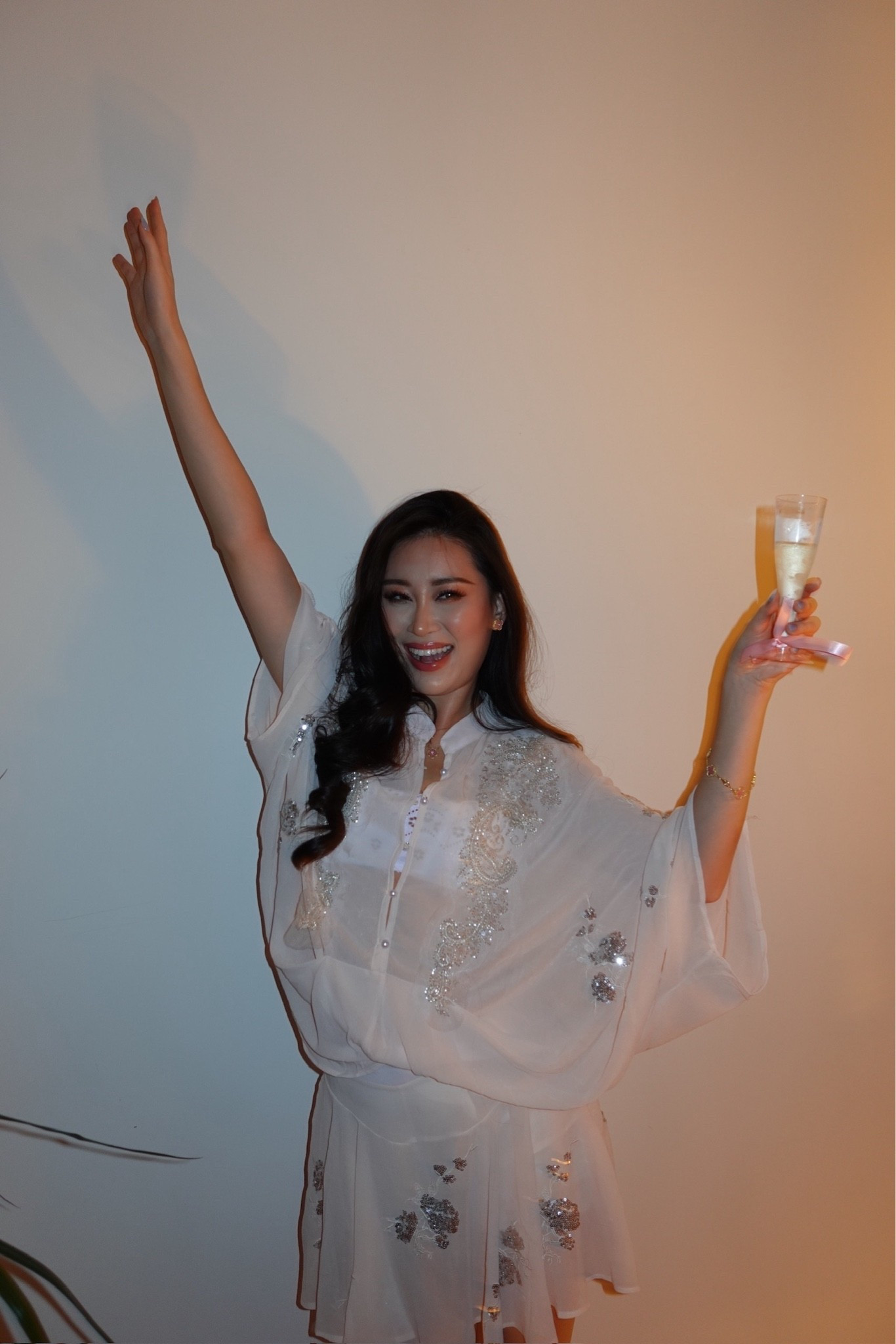 baby pink chiffon kaftan set with silver sequin floral appliqué and a relaxed kimono-sleeve silhouette, styled with delicate gold jewelry. the floaty chiffon and hand-beaded detailing make this an effortless throw-on piece that feels special without trying too hard. perfect for resort evenings, poolside parties, celebratory dinners, and warm-weather getaways. shop this look linked above.