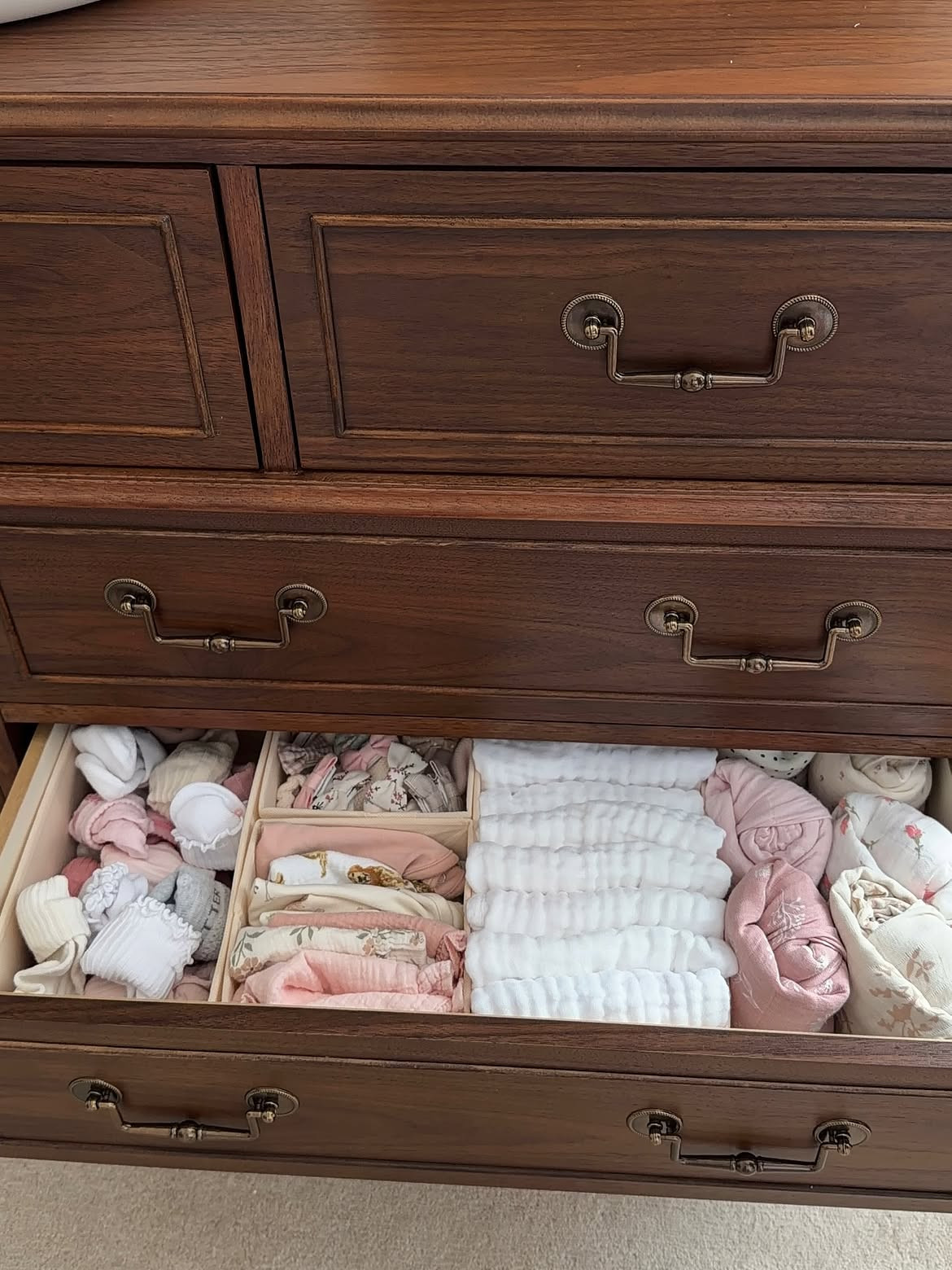 Organizing in baby girl’s new dresser 😍🎀