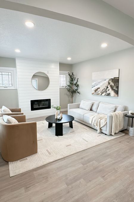 Living room ✨ 

Accent chair, sofa, area rug, fireplace, art, large canvas, coffee table, side table, round mirror, styling, decor, home staging 

#LTKhome #LTKstyletip #LTKsalealert