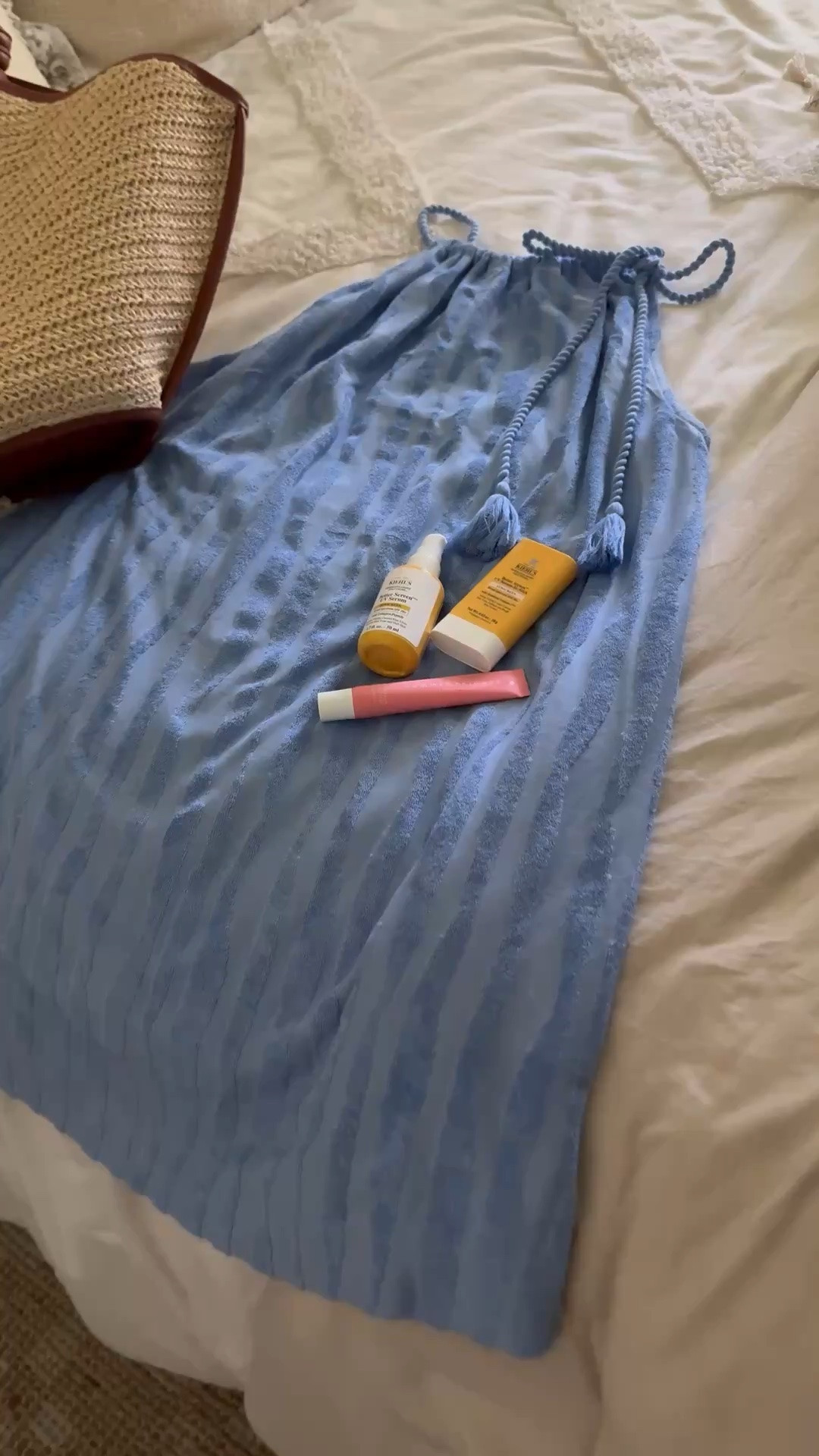 Cute swimsuit coverup, sunscreen, lip gloss and woven bag for a cute vacation look.