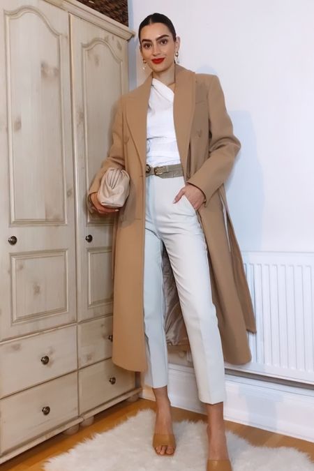 Neutral outfit idea 🤍✨

Camel coat, one-shoulder top, high waist trousers, large belt, beige clutch, nude mules

#LTKSeasonal #LTKstyletip