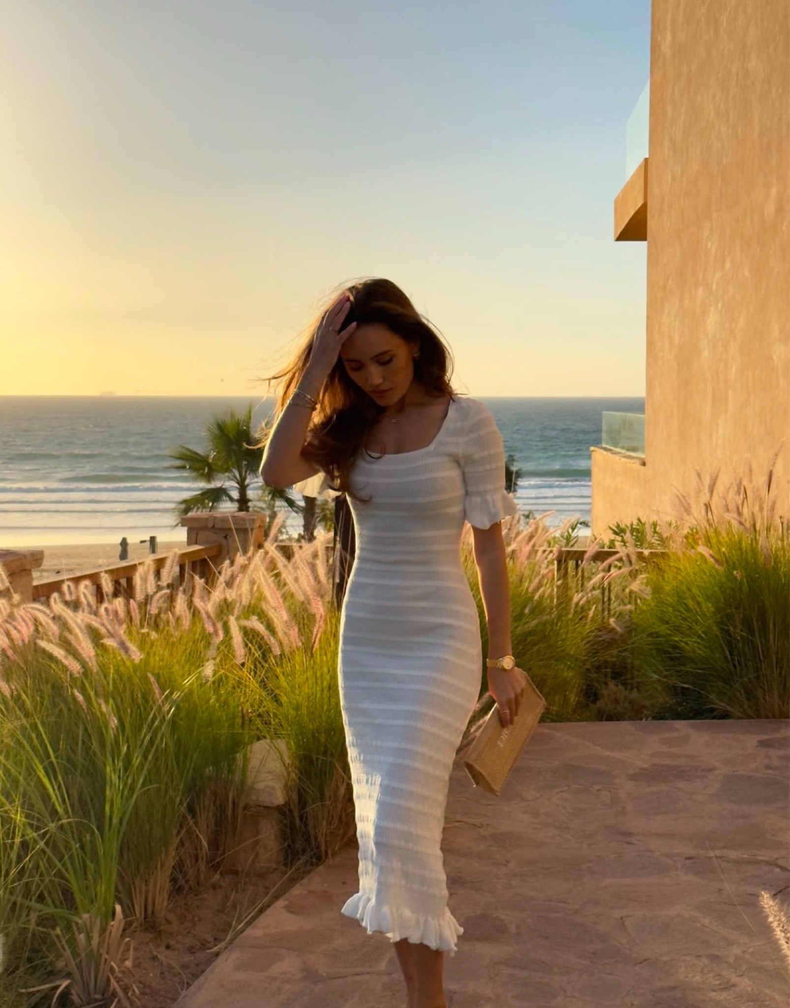 Golden hour, the perfect holiday vibe at sunset in a summery white dress 🌅 the dress is the Chantilly Knit Dress from Aavelle, styled with Dior raffia straw clutch bag and Hermes Oran sandals, similar items linked below 

#LTKtravel #LTKstyletip