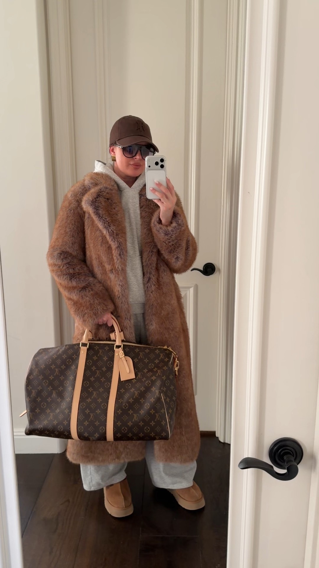 Winter outfit inspo. Wearing Zara long fur coat size S. They are selling out fast! Tagging similar coats below in case it’s not available anymore. Styling with grey sweats & a hoodie, a cap, aviators, Uggs and Keepall 50
#winter #outfit #furcoat #winteroutfit #coat #louisvuitton #keepall #cap #brown #grey #hoodie #espressobrown #sweatpants #uggs 

#LTKootd #LTKFindsUnder100 #LTKSeasonal