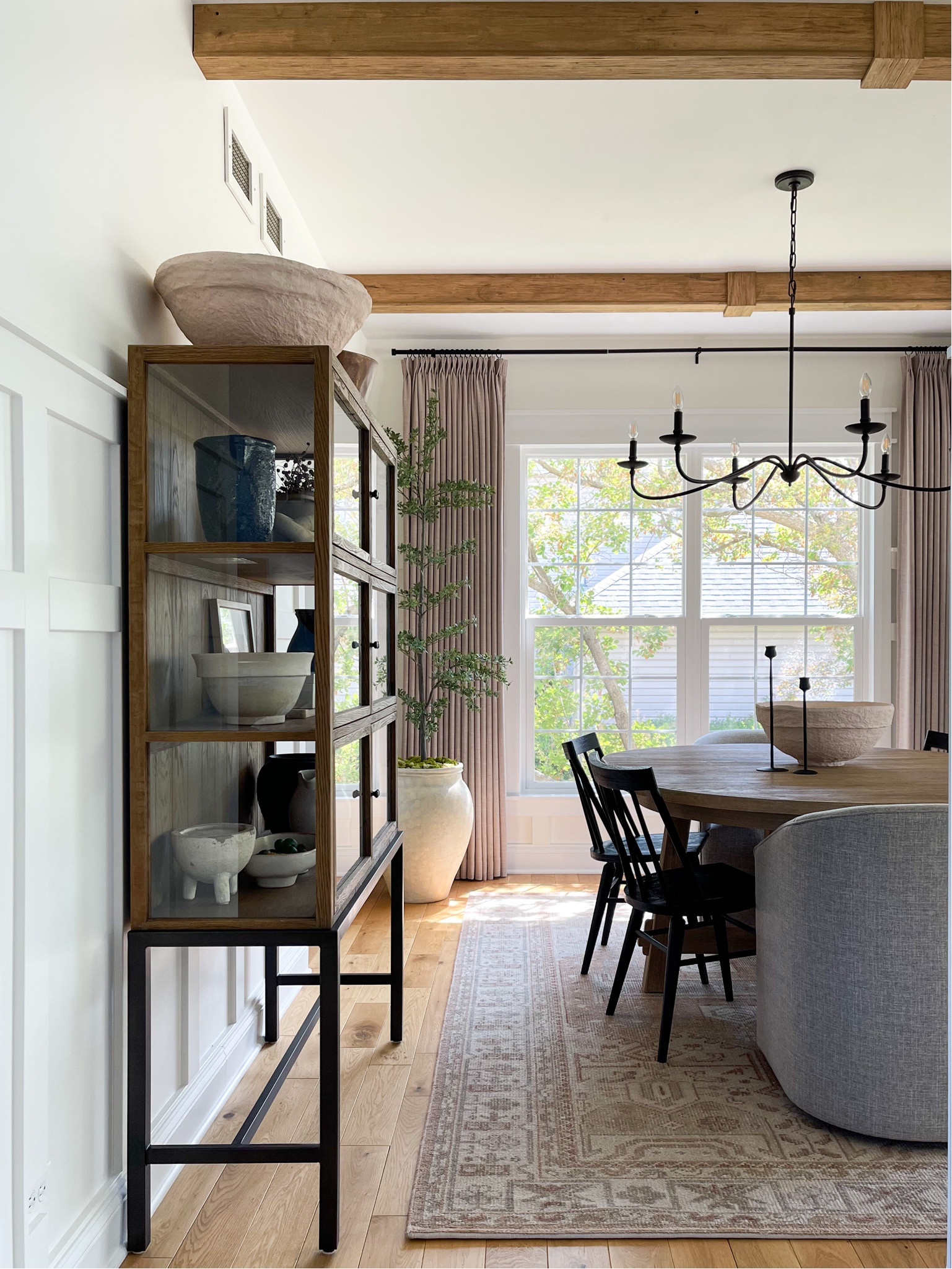 Dining room, home decor, neutral styling, wood beams, triple pleat curtains, custom curtains, linen curtains, wool rug, Pottery Barn, round table, oval table, barrel chairs, black chairs, transitional design, home design, dining room, interiors, home

#LTKhome #LTKFind #LTKsalealert