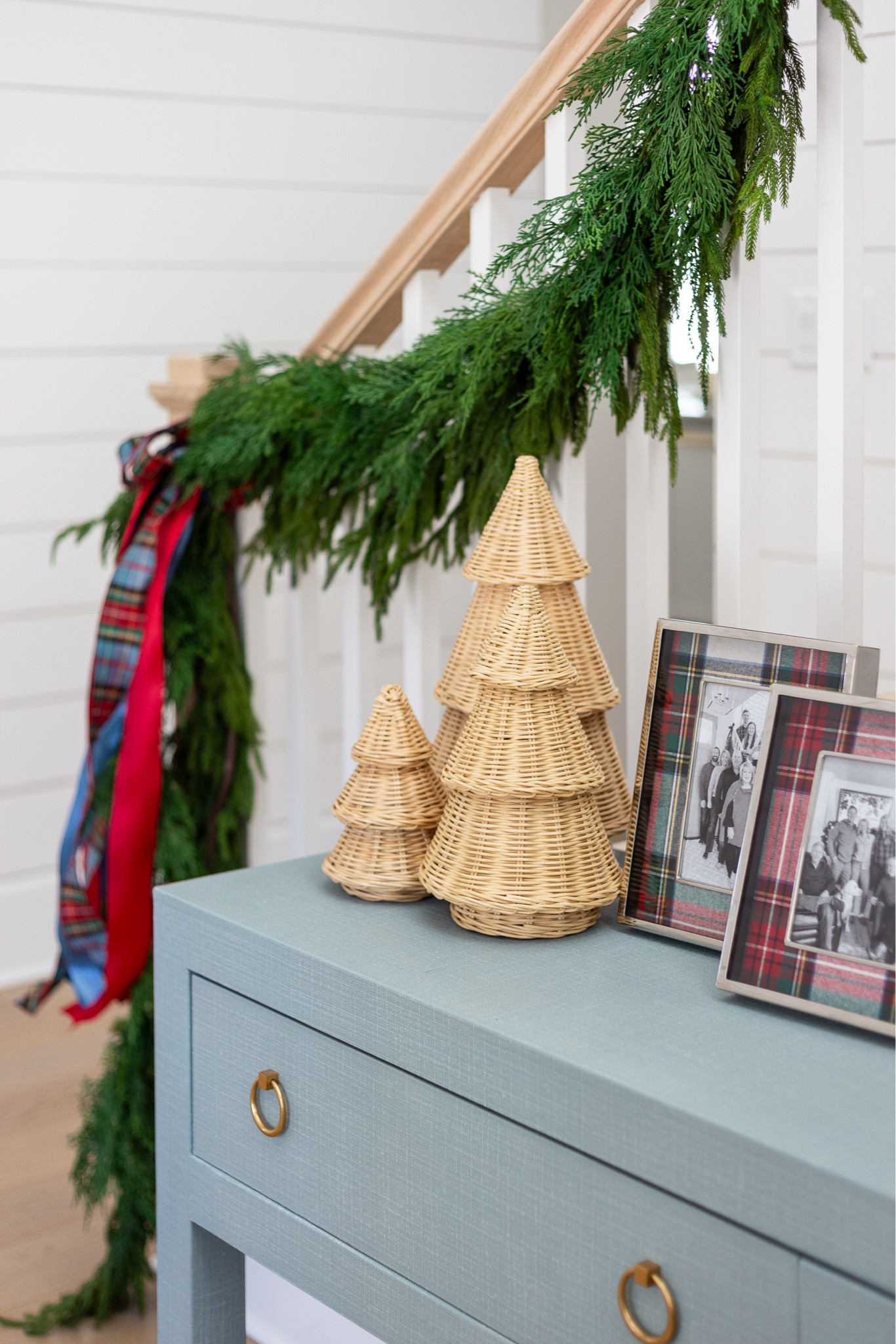 Our coastal entryway decorated for Christmas with two types of garland (real-touch Norfolk pine and faux cedar), plaid bows, our blue linen console table, seagrass table lamp, wicker Christmas trees, Stewart plaid pictures frames, and a gold Moravian star chandelier. See our full Christmas home tour here: https://lifeonvirginiastreet.com/2024-christmas-home-tour/ #ltkholiday #ltkhome #ltksalealert #ltkfindsunder50 #ltkfindsunder100 #ltkstyletip #ltkseasonal 

#LTKHome #LTKHoliday #LTKSeasonal