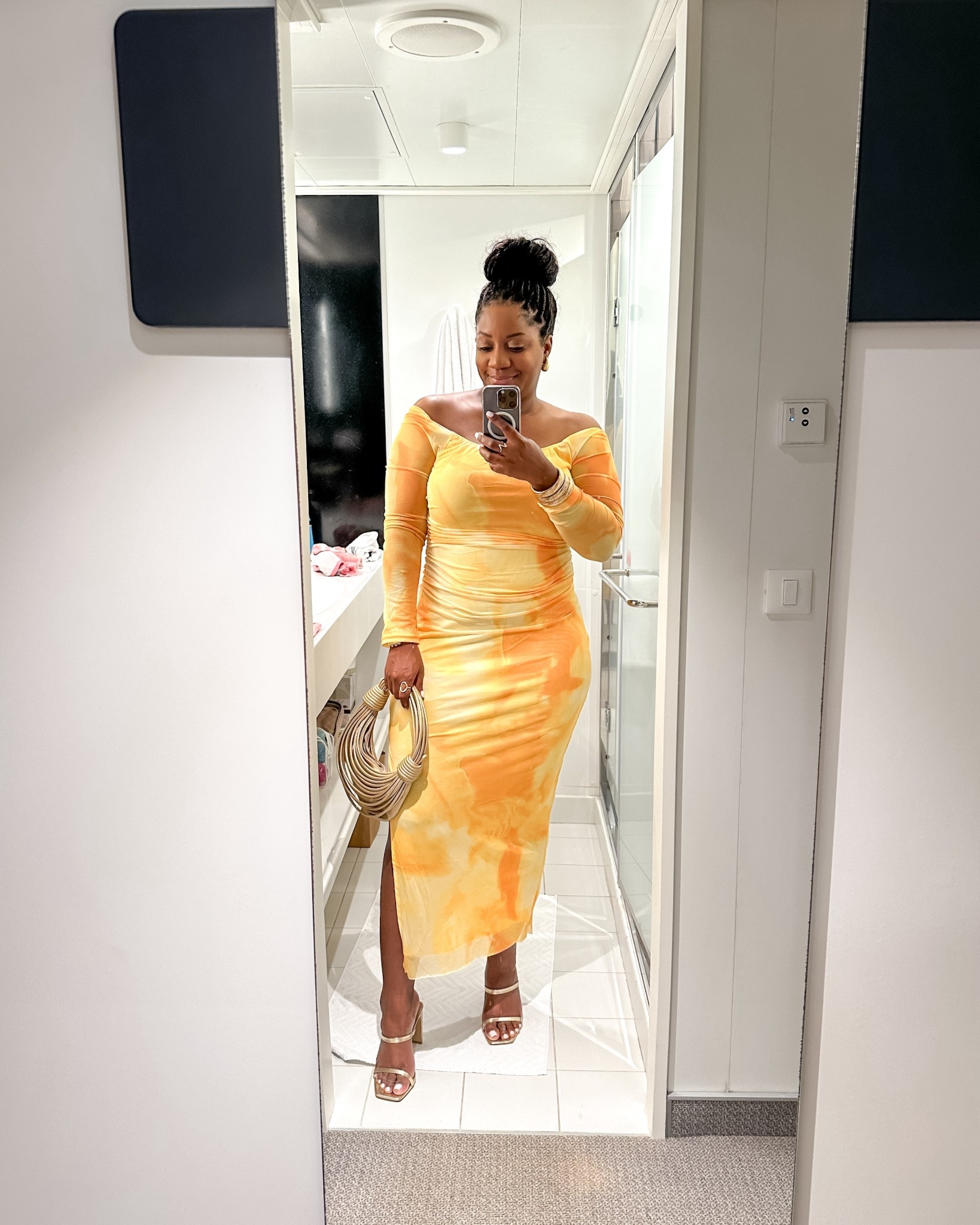 Love this yellow and orange off-the-shoulder long sleeve midi dress with ruching and a side slit. Paired with gold heeled sandals and a structured top-handle bag for a bold vacation-ready statement. Wearing a L in the dress.

off shoulder dress with sleeves / yellow midi dress / long sleeve bodycon dress / vacation dinner outfit / tropical date night look / sunset colored dress / ruched midi dress with slit / resort outfit idea / midsize vacation dress / statement sleeve dress

#LTKMidsize #LTKootd #LTKSeasonal