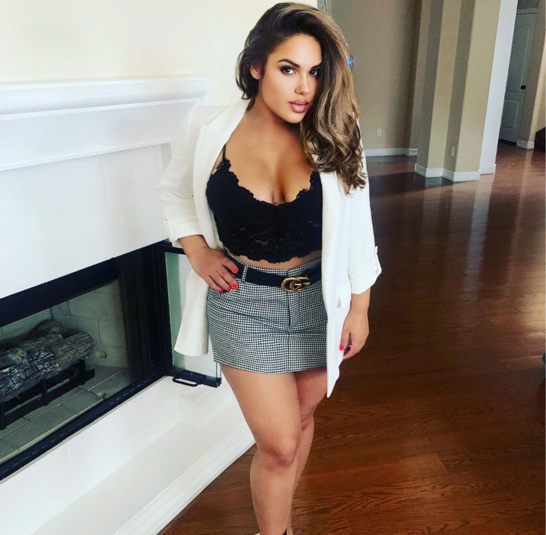 Wearing a cropped black lace spaghetti strap top with a white blazer, black and white skirt and a Gucci belt. 

#LTKstyletip #LTKfindsunder100 #LTKSeasonal