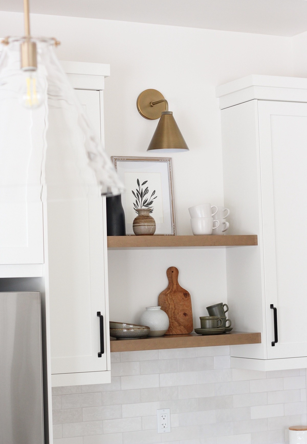 Sharing brass sconce above wood shelves + pendants over island in our kitchen.

#LTKHome