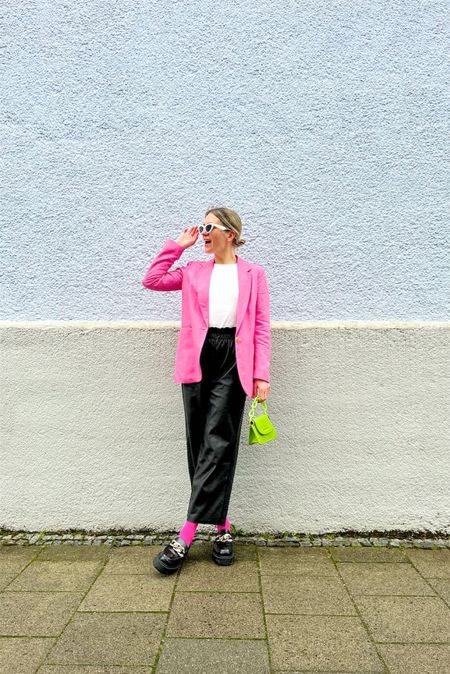 Pink Blazer. Fashion Blogger Girl by Style Blog Heartfelt Hunt. Girl with blond sleek bun wearing a pink blazer, white top, white cat-eye sunglasses, neon green mini bag, faux leather pants, pink socks and chunky loafers. #pinkblazer #springlook #pinkoutfit #colorfuloutfit #colorfulstyle #colorfulfashion #colorfullooks #fashionfun #cutespringoutfit #springfashion2023 #springlookbook #fitcheck #dailylooks #dailylookbook #contentcreator #microinfluencer #discoverunder20k