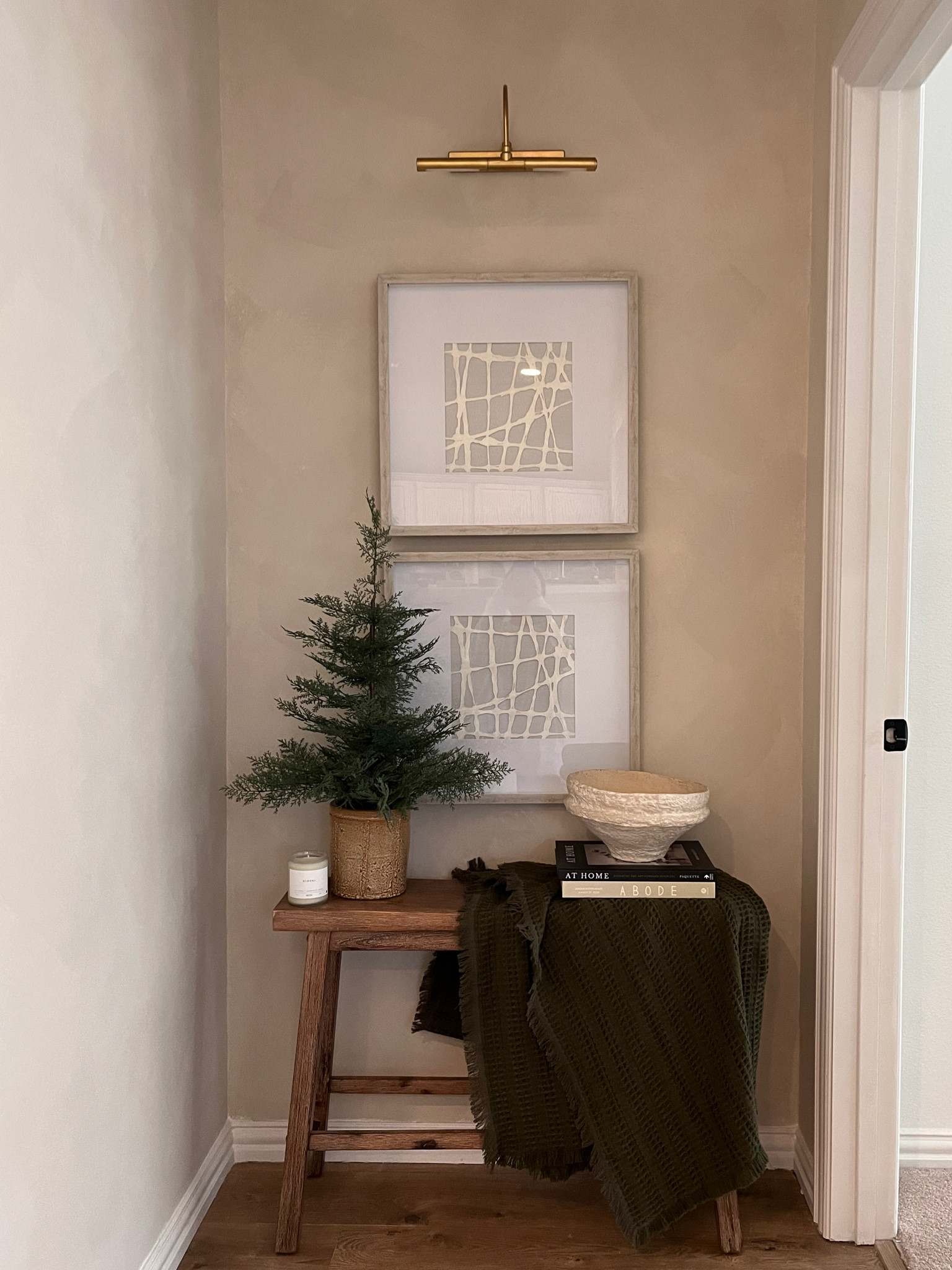 Hallway nook decor. New lighting from Nathan James - code MANDY10 Gets you a discount SITEWIDE! 

Bench, art, Christmas tree, Christmas decor, blanket, paper mache bowl, rice paper art, picture light 

#LTKHoliday #LTKSeasonal #LTKhome