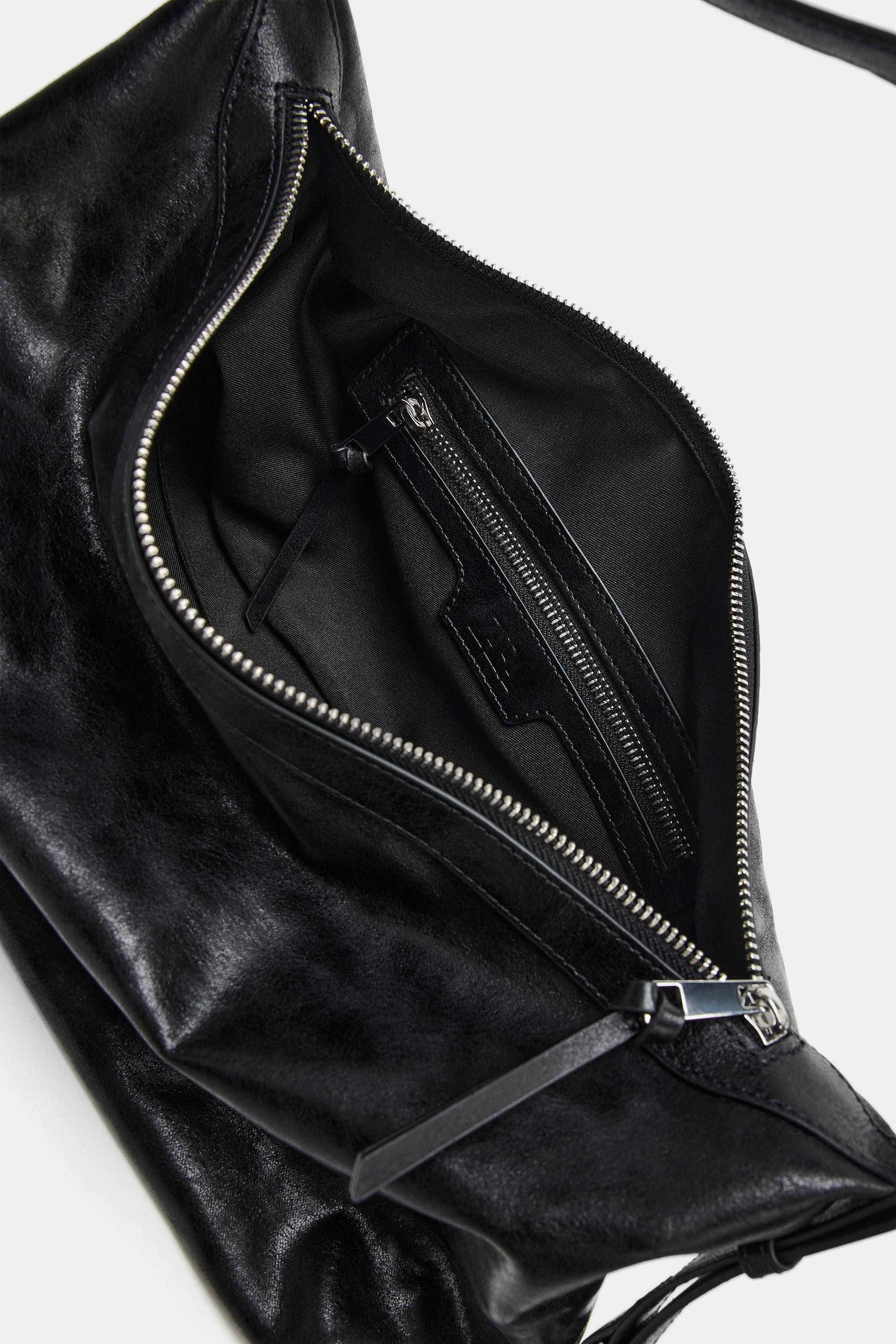 Model height: 179 cmShoulder bag. Adjustable shoulder strap. Buckle and metallic hardware detail ... | Zara UK