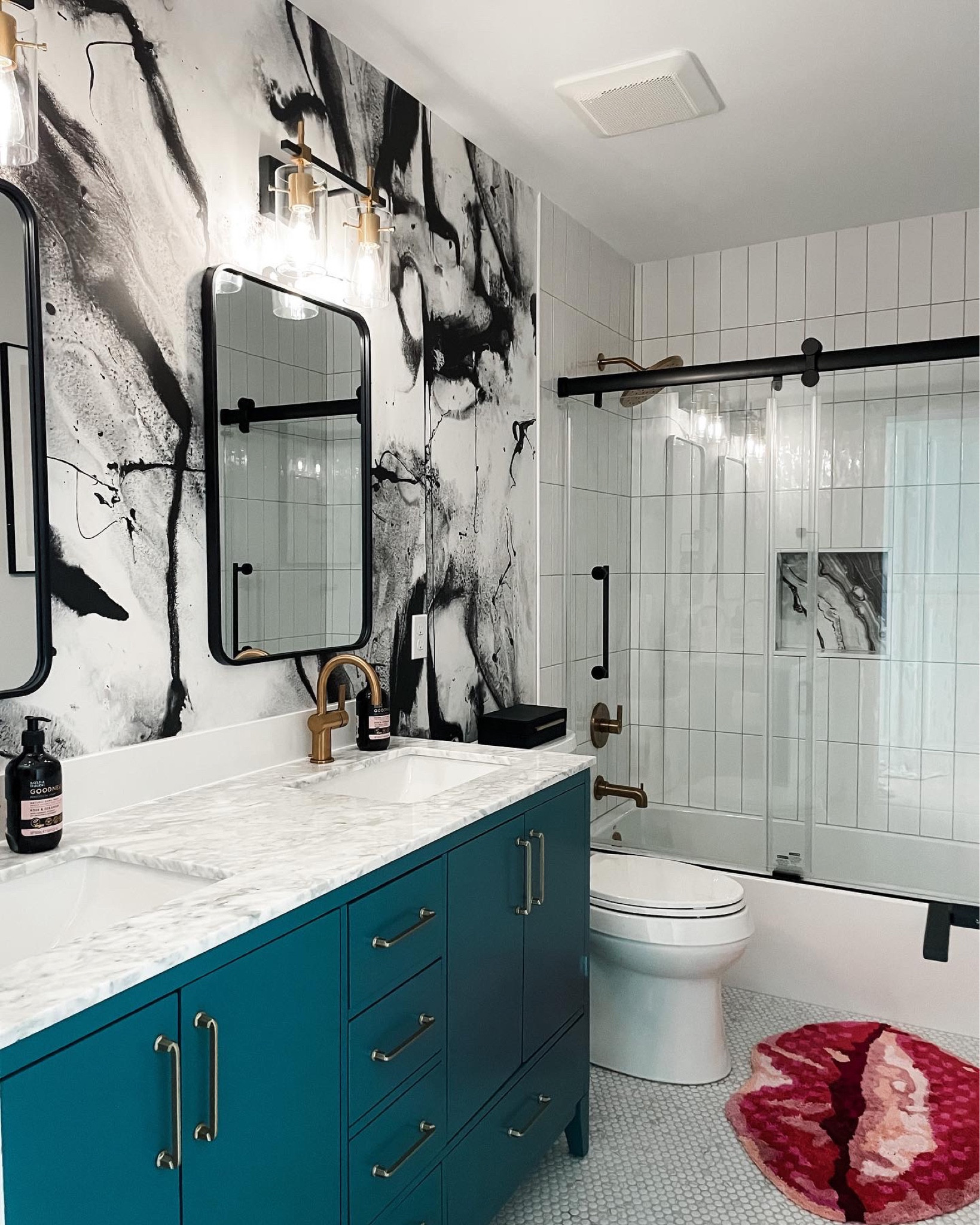 Our recently renovated Girls’ bath is new favorite room in the house! ❤️‍🔥

We opted for a grounding palette of black, white and gold with pops of color for added whimsy. 💋 Every time we walk past this room it sparks joy! 

Style tip:
✨Invest in the unique key pieces that make your space feel bespoke and personal, and find less expensive alternatives where options are plenty. In our case, we splurged on the wallpaper and vanity and let budget lead (without sacrificing style) with the lights and mirrors. 
✨Make every decision (right down to the details) based on what lights you up and makes you feel alive! The more unexpected, the more reflective of who YOU are… always the better! ⚡️

#LTKstyletip #LTKhome #LTKfamily