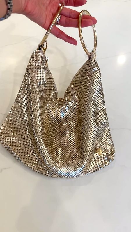 Sparkly bag in gold tone metal mesh to pull together those holiday looks! ❤️ This bag can be held by its ring top handles which also slide over your wrist, and comes with a detachable chain link shoulder strap. The perfect accessory for my New Year’s Eve look!! 

#LTKparties #LTKHoliday #LTKitbag