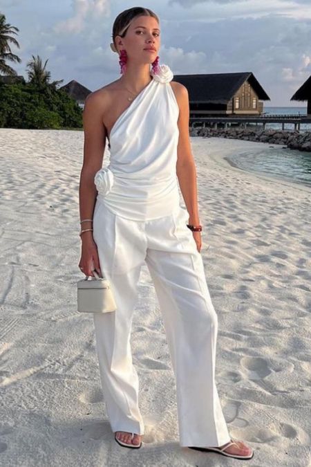 Sofia Richie’s one shoulder cotton rose white top pouch leather bag white trousers thong sandal

#LTKwedding #LTKFind #LTKstyletip