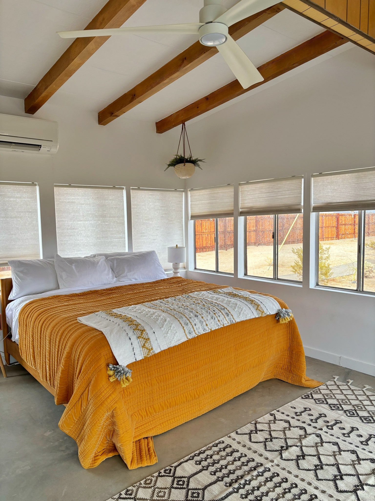 Low profile mid century bed in our desert Airbnb.  I didn’t want to block the windows and the windows are on every wall!  The comforter is from Target.  