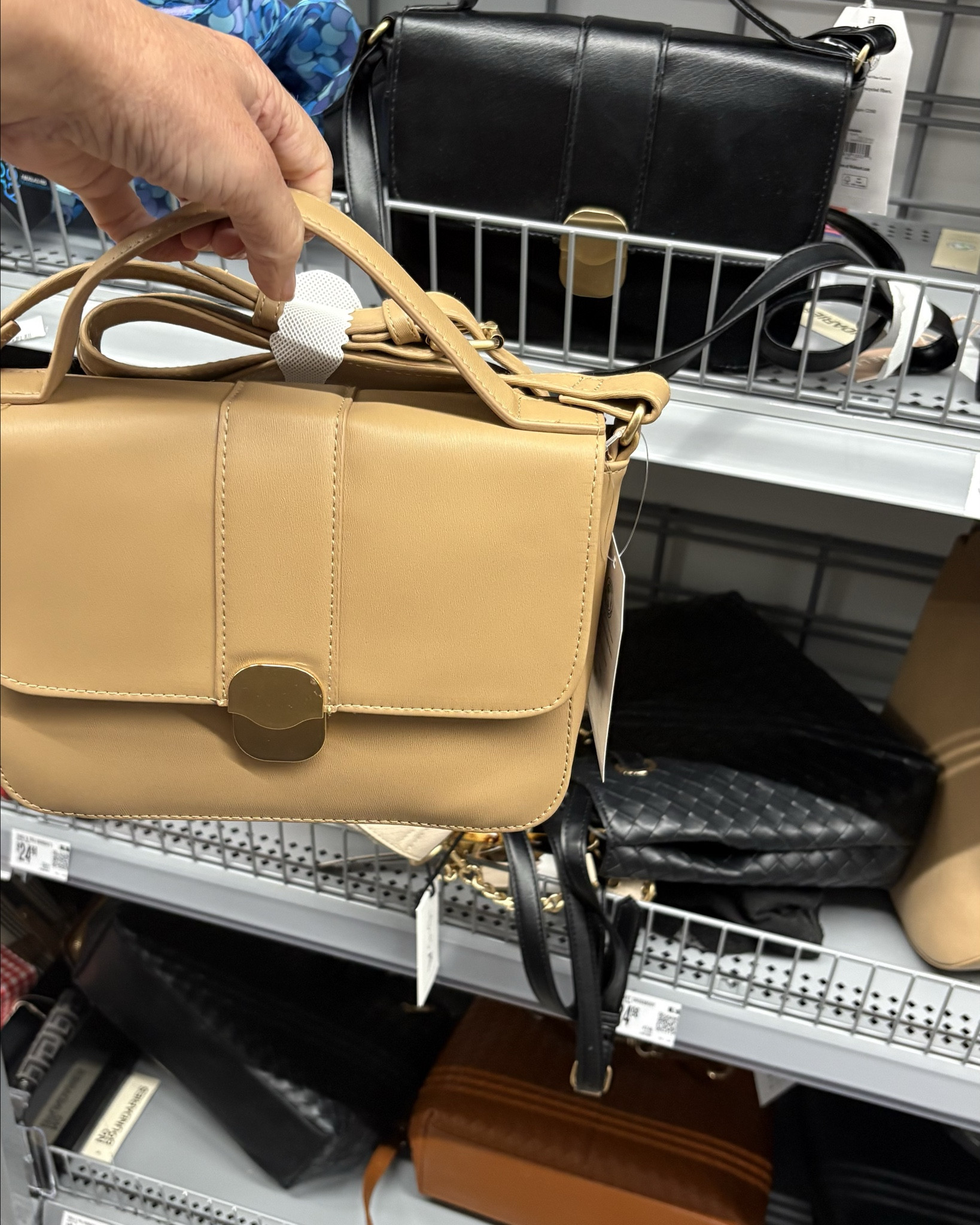 The cutest purse with handle or crossbody style. It has gold-tone hardware which steps it up a bit  