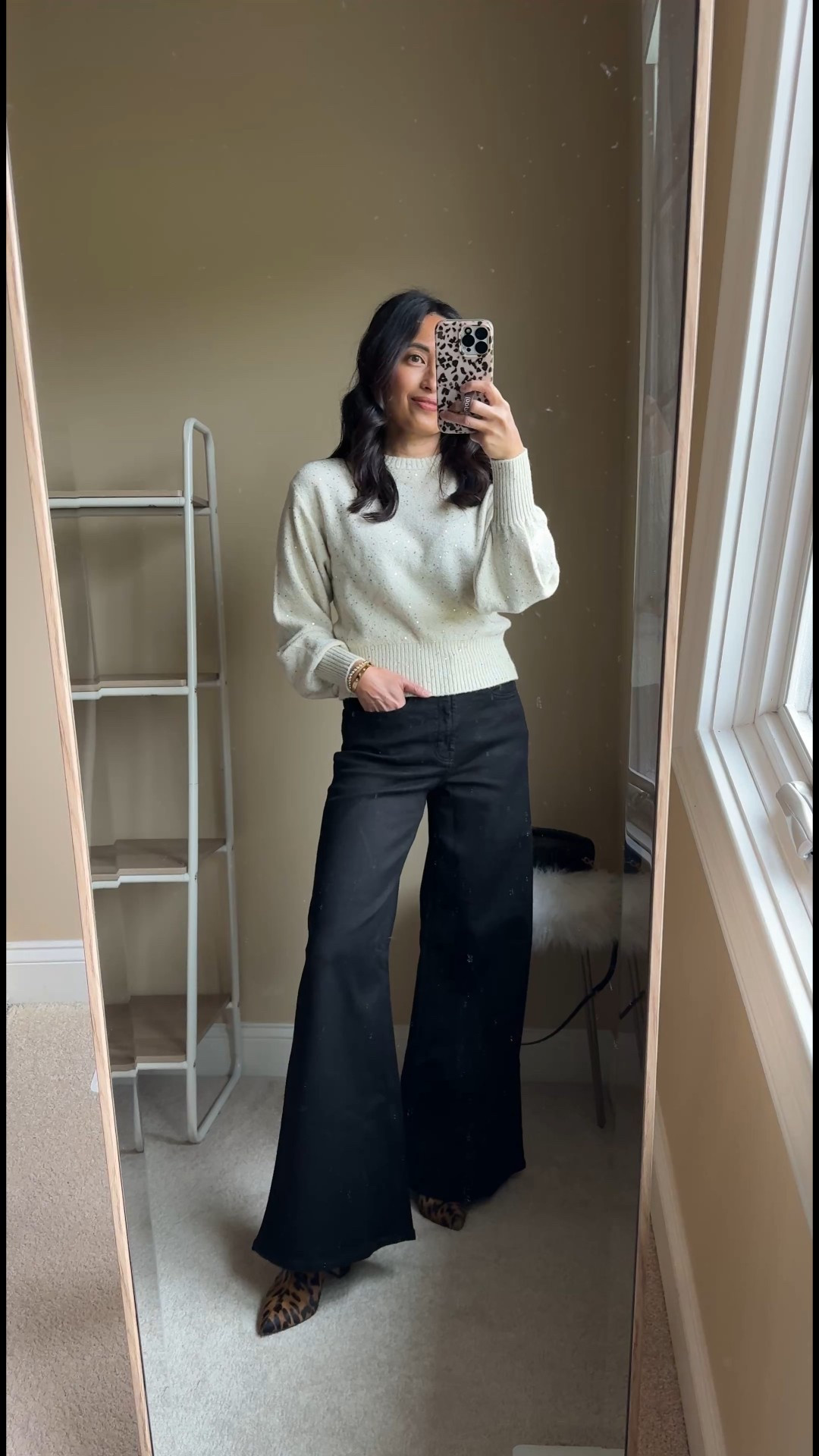 Easy casual chic festive outfit. 
If holiday red isn’t for you, a neutral holiday vibe is just as easy. 
-This embellished sweater has a pretty blousy feel to it. Feels effortlessly fancy with the subtle shimmer from the tiny sequins throughout. True to size for me. On sale for $36. 
-Black jeans that can pass for dress pants if you don’t really want or need dress pants. The high-waisted, wide leg silhouette is a flattering fit and feels elevated. Stretchy denim material.  True to size and in regular length here; could also wear petite length for flat shoes. On sale for $48. 
-Simple gold jewelry for more shimmer. 
-Leopard print shoes for interest. 


#LTKFindsUnder50 #LTKHoliday #LTKOver40