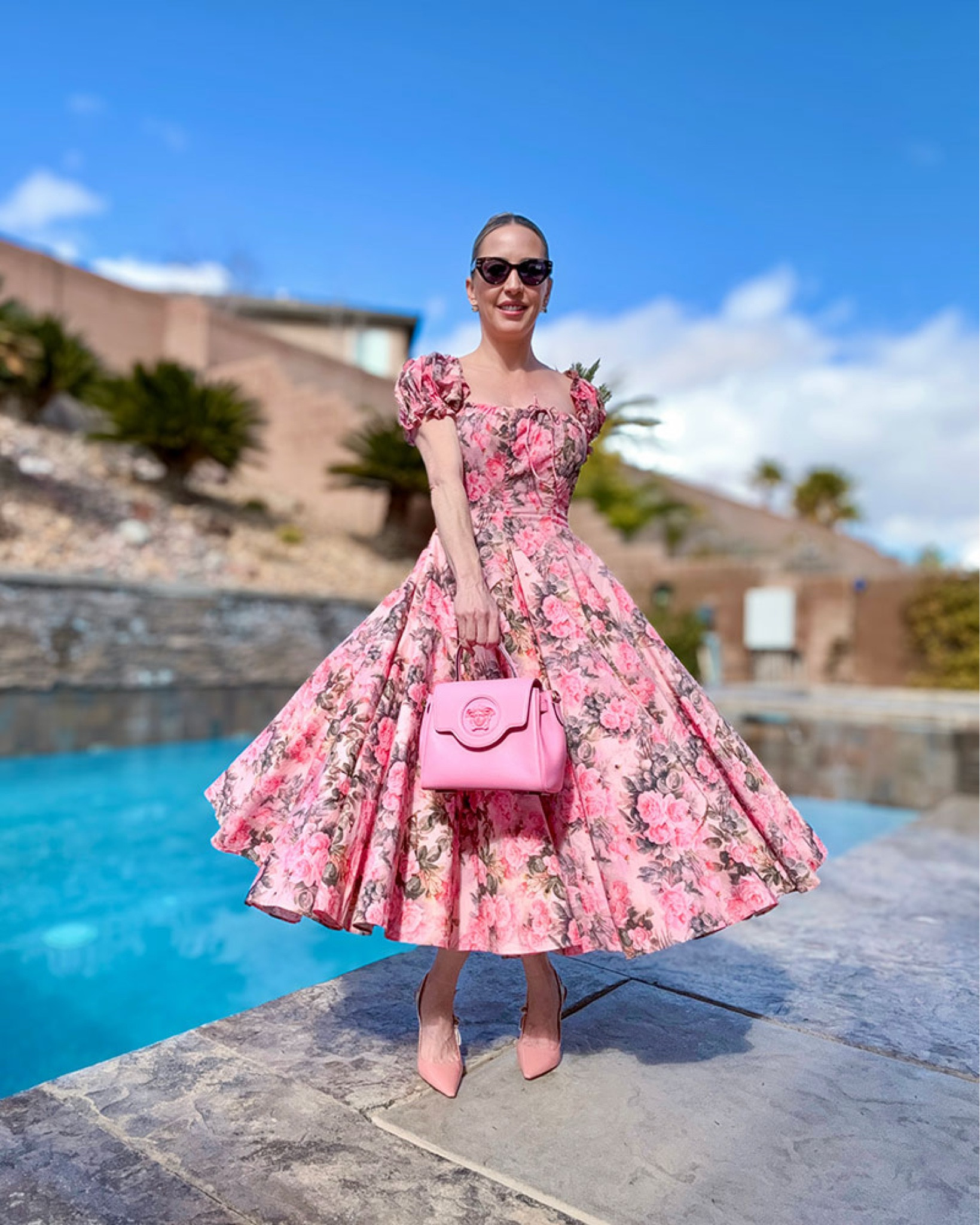Pink floral dress on major sale! This pink midi dress would be a super cute Garden party dress, Kentucky Derby dress, Valentine’s Day dress or brunch outfit. It’s under $150 on sale and checks off the candy pink color trend for 2025. Styling them with pink slingback heels and a pink top handle bag 💕 

#LTKParties #LTKSeasonal #LTKSaleAlert
