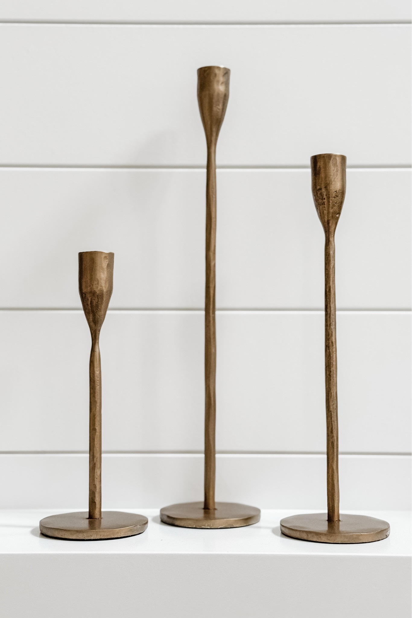 I have been on the hunt for a set of candlestick holders for the house for almost two years! I debated between black and brass finishes and wanted two sets of three in varying heights and in an elegant-yet-simple design. I looked at a variety of options and every other brass set’s finish was too “bright” and shiny, too flimsy, or too ornate (or all three!). This beautiful set ended up being the perfect solution! 

I do love the classic iron set as well, but I think we’ll get more use out of the brass ones in our house.

#LTKHome #LTKHoliday