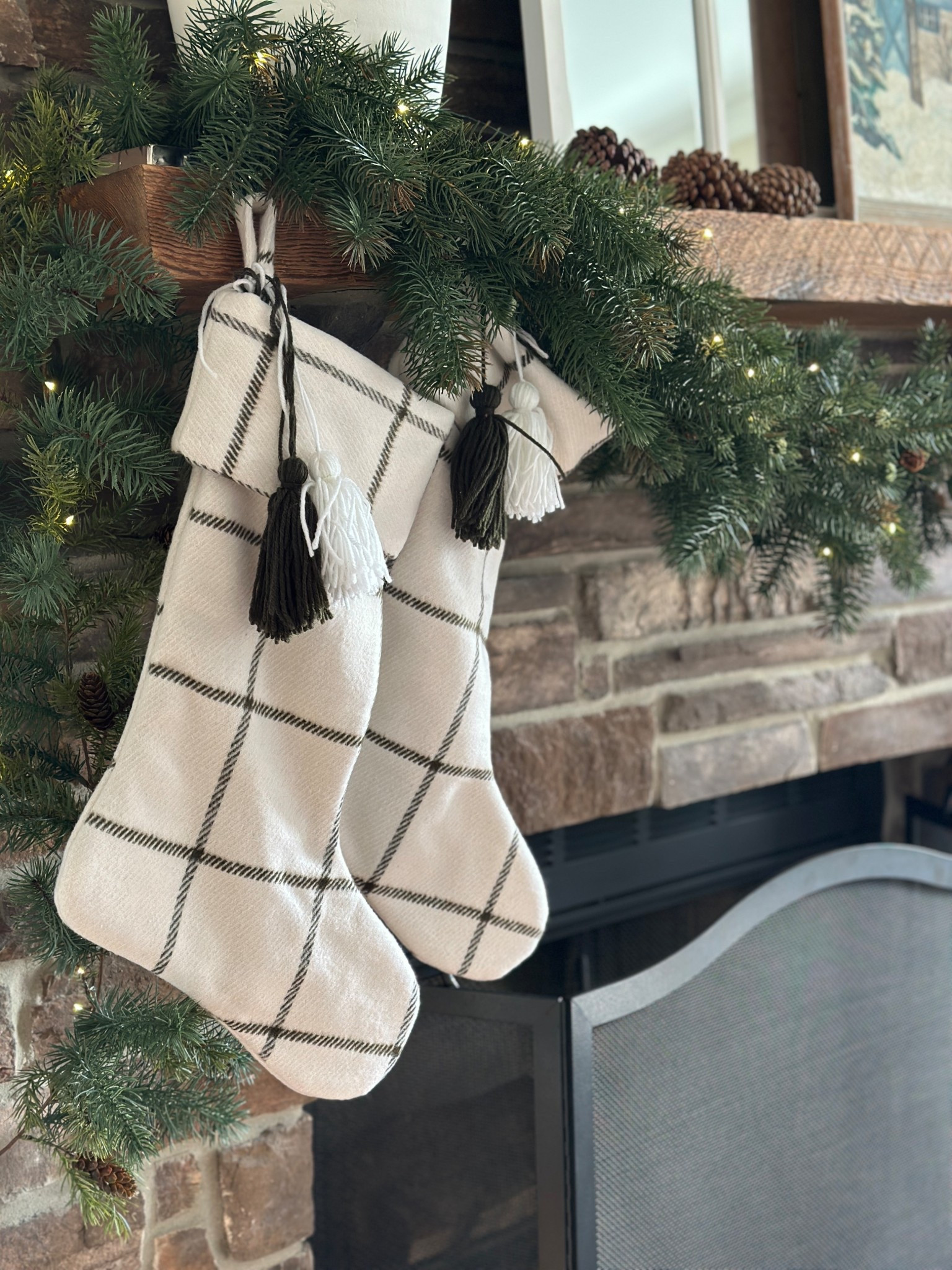 Classic window pane Christmas stockings on mantel with black fireplace screen.

#LTKHome #LTKSeasonal #LTKHoliday