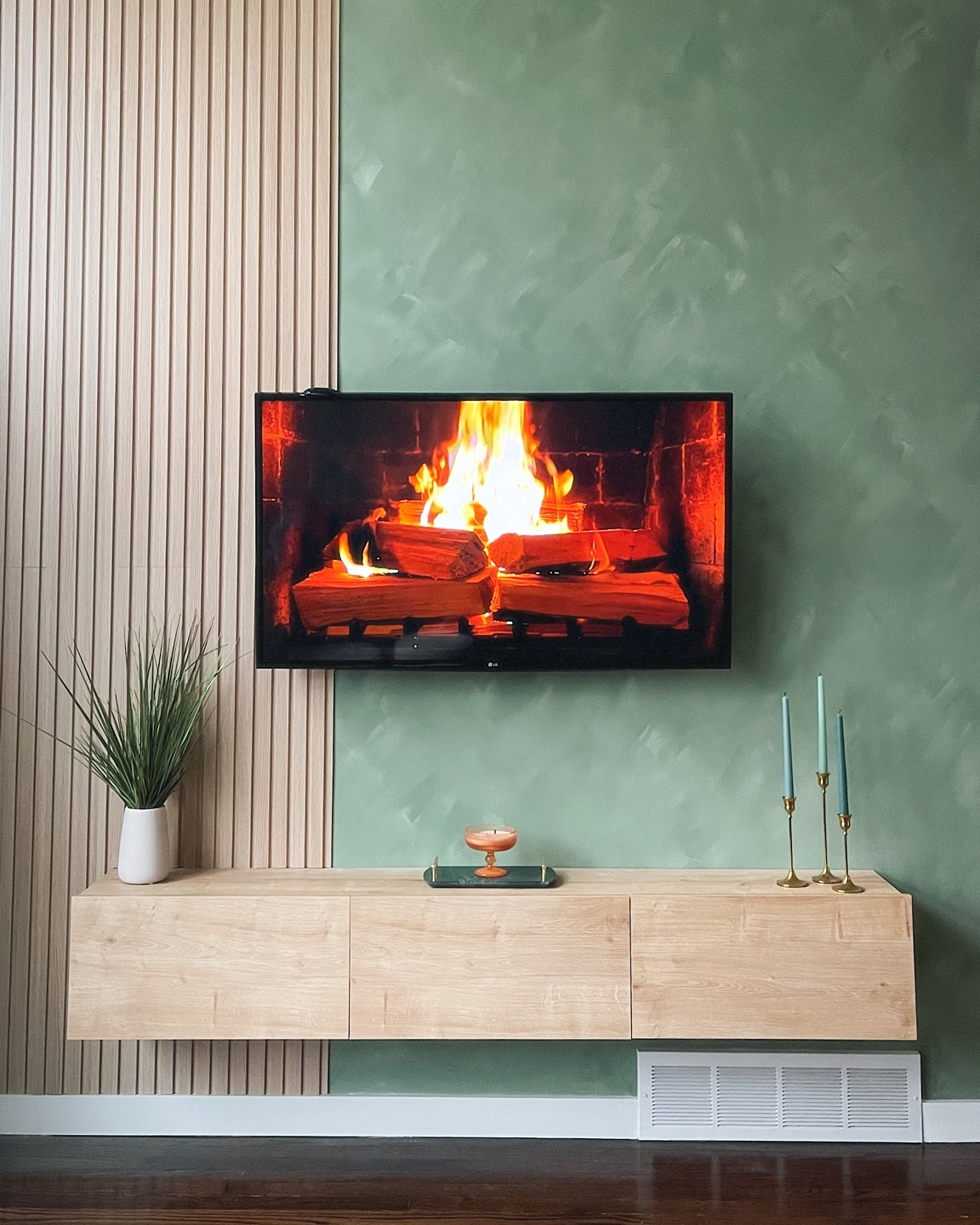 so fun to see our vision for the tv area come to life!! 📺💚

Home Depot $15 wood paneling - we bought 10 & did 5 panels wide. Our wall is 12 feet tall so after all said and done, we had one full board left over + extra pieces! 

Floating shelf - Wayfair

Paint - faux lime wash technique using Behr jojoba + eucalyptus wreath in flat matte 

#LTKHome