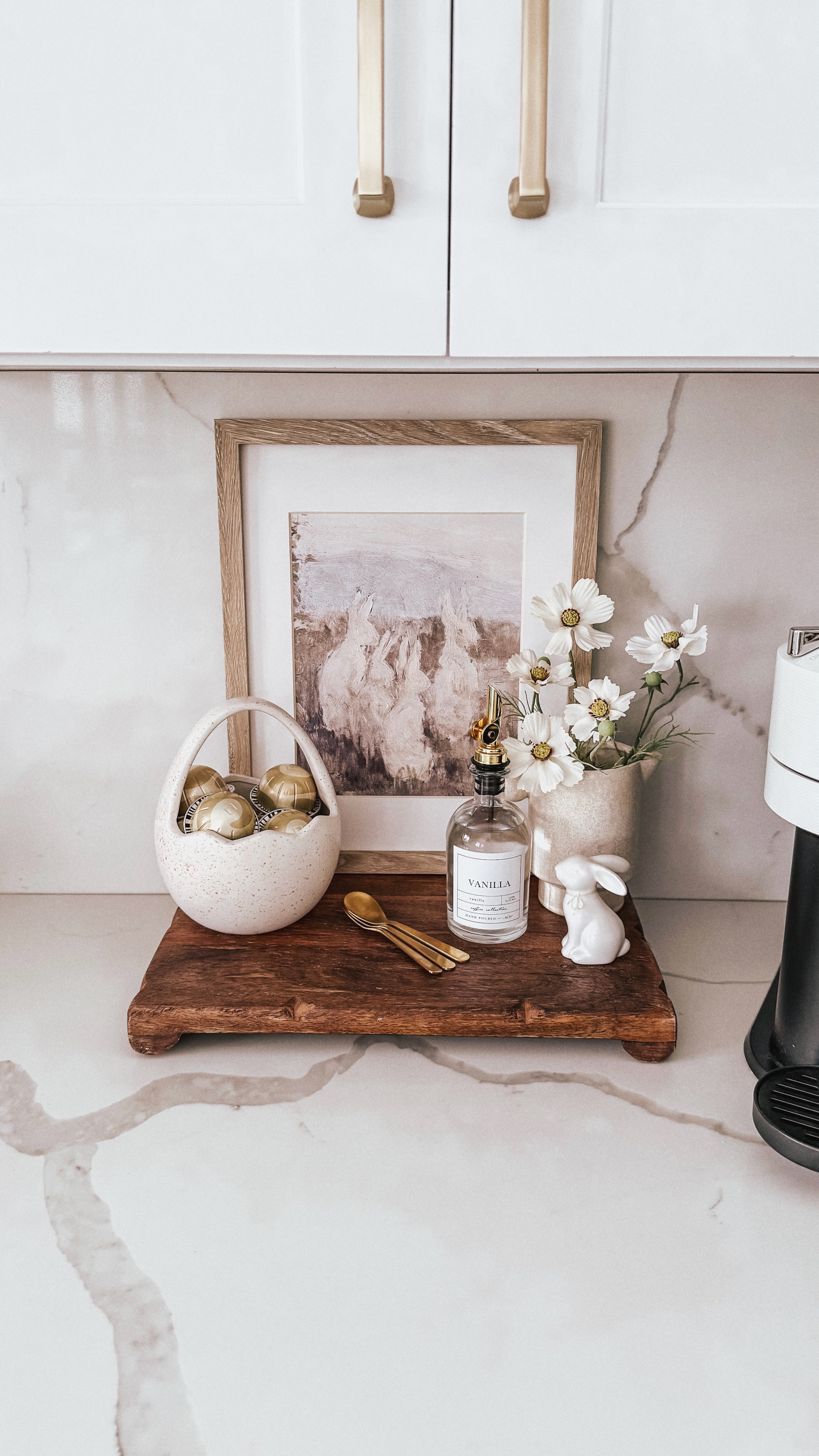 Spring coffee bar 🐇 ☕️ 🌸 Adding the cutest Easter touches to my fav little spot in the kitchen with a bunny print, a tiny egg basket for pods, golden spoons, and pretty florals.

#SpringCoffeeBar #EasterCoffeeStation #KitchenDecor #CoffeeLover #SpringDecor #HomeDecorLover #CoffeeBarIdeas #eastercoffeebar #easterdecor #coffeebar #nespresso #easterprint 
#liketkit #Itkhome #Itkunder50 #Itkseasonal #easterbrunch #easter

#LTKWatchNow #LTKHome #LTKSeasonal