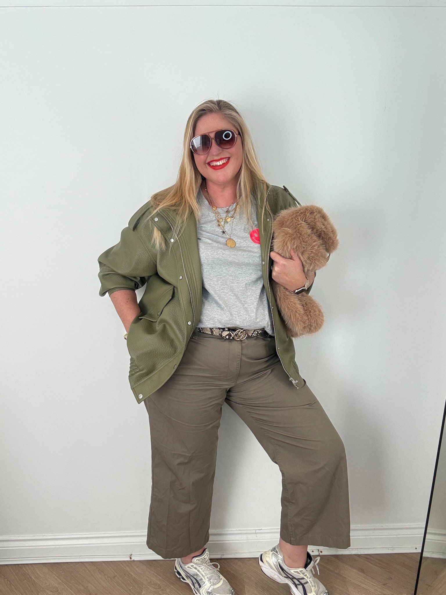 Grey tshirt, green faux leather jacket, khaki trousers, trainers, sunglasses, faux fur bag, lipstick 

#LTKstyletip #LTKspring #LTKplussize