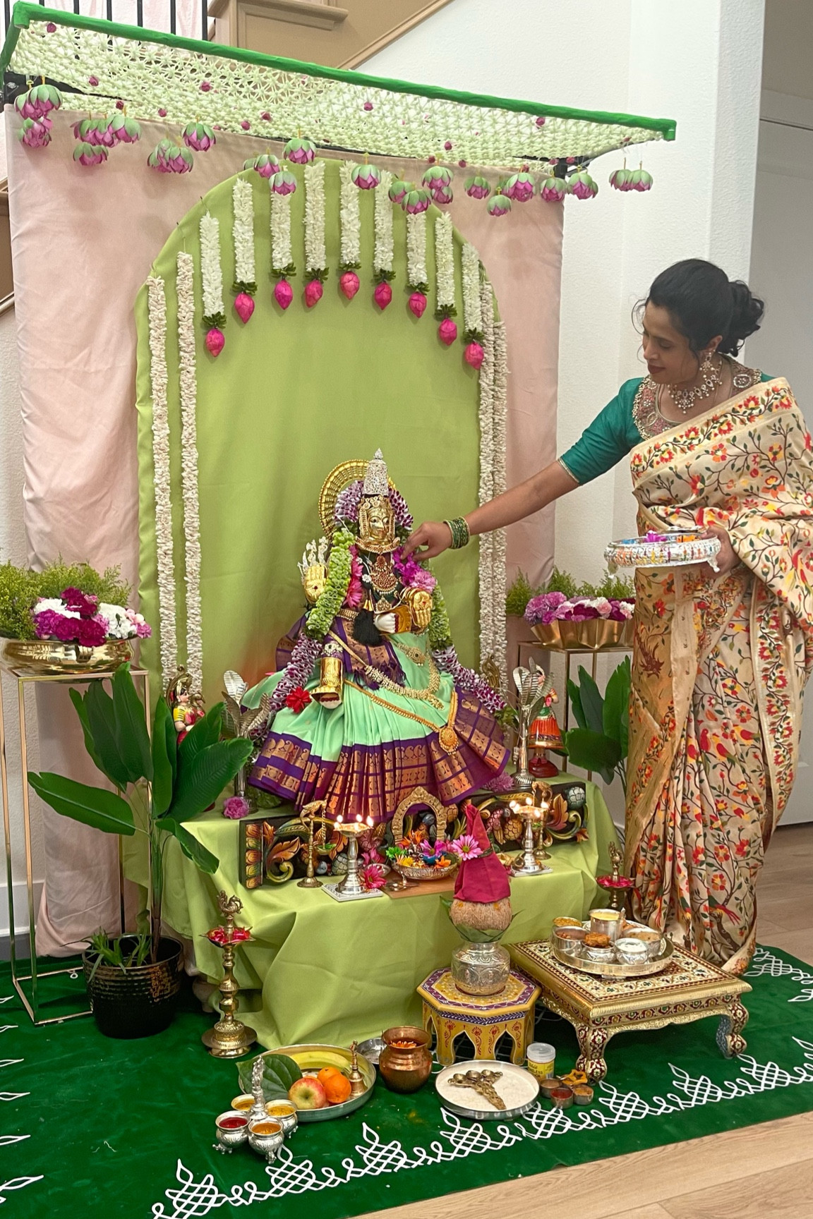 Behind the scenes of getting our ammavaru ready for the big day. As a kid - I’ve seen mom decking up ammavaru idol and I wanted to continue the legacy , though we don’t have the tradition on my in-law side. 

Spending hours and decking up ammavaru gives immense satisfaction.  Barely had some time to try out any new DIY. I had ordered the below ornaments 1 month ahead of the event .  But tried to repurpose most of the decorations.

Details below 👇🏼 

Ammavaru saree - @indyvoguellc 
Ammavaru face , full crown , devi alankarana hands , arch, hastham and padam decoration - @thugilonline 

Hope that helps!!

[diy backdrop, Indian decor , Indian decor ideas , simple backdrops , Indian festival, indian festival decor , varalakshmivratham, varalakshmivratham decoration, ammavaru alankarana, saree draping, ammavari alankarana, devi alankarana] 

#indianfestival #indianfestivals #poojabackdrop #poojabackdropdecor #varalakshmivratham🙏 #varalakshmivratham #varalakshmivrathamdecoration #varalakshmivrathamspecial♥️ #diydecor #decorreels #behindthescenes #indiandecor #indiandecorideas #indiandecoration #festivalreels #decorreels #reelsindia #reelsinstagram #devialankaram #ammavaru #ammavaru🙏


#LTKwedding #LTKhome