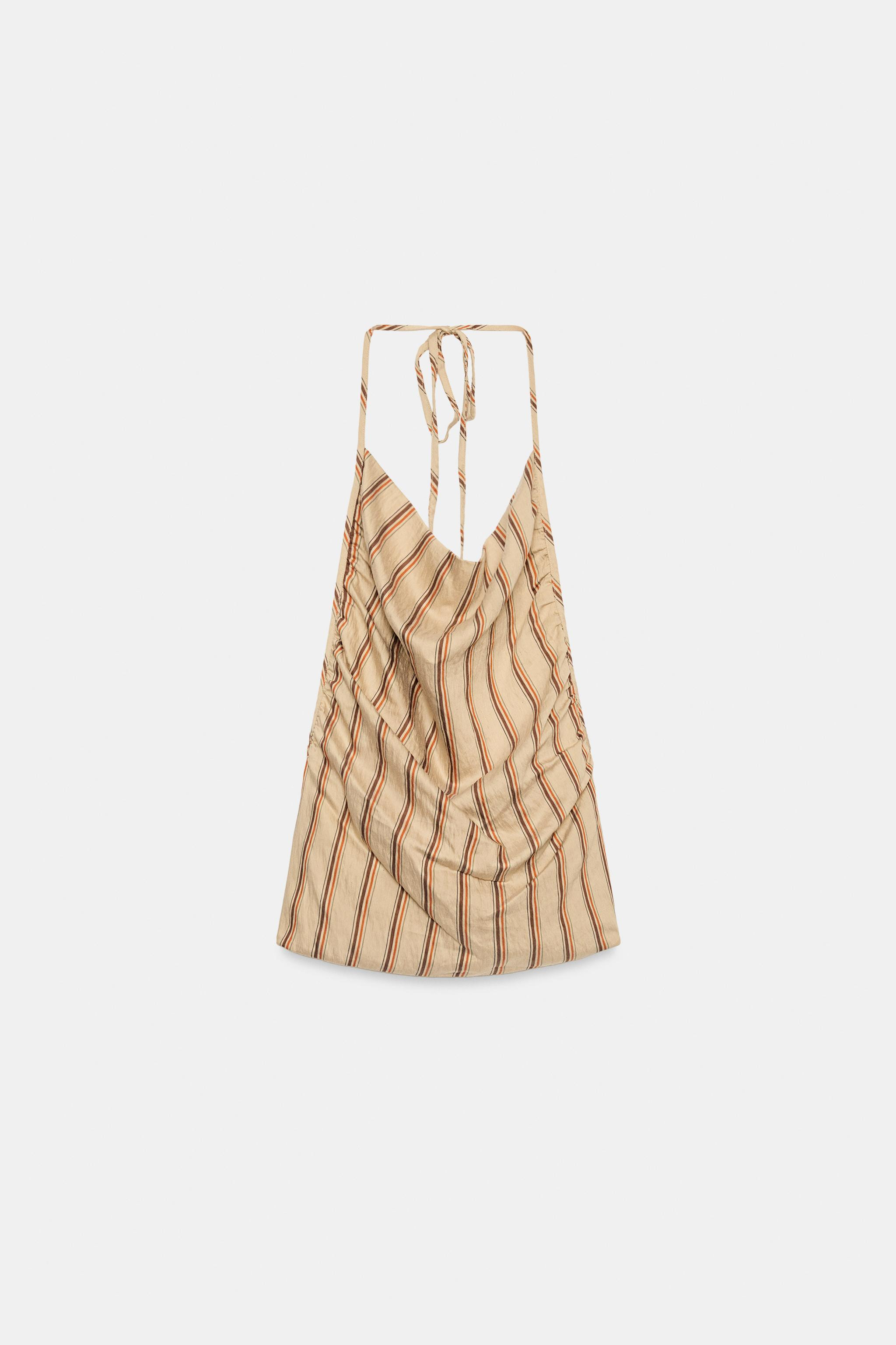 Model height: 181 cmHalter neck top with a draped neckline. Open back. Featuring gathered side de... | Zara UK