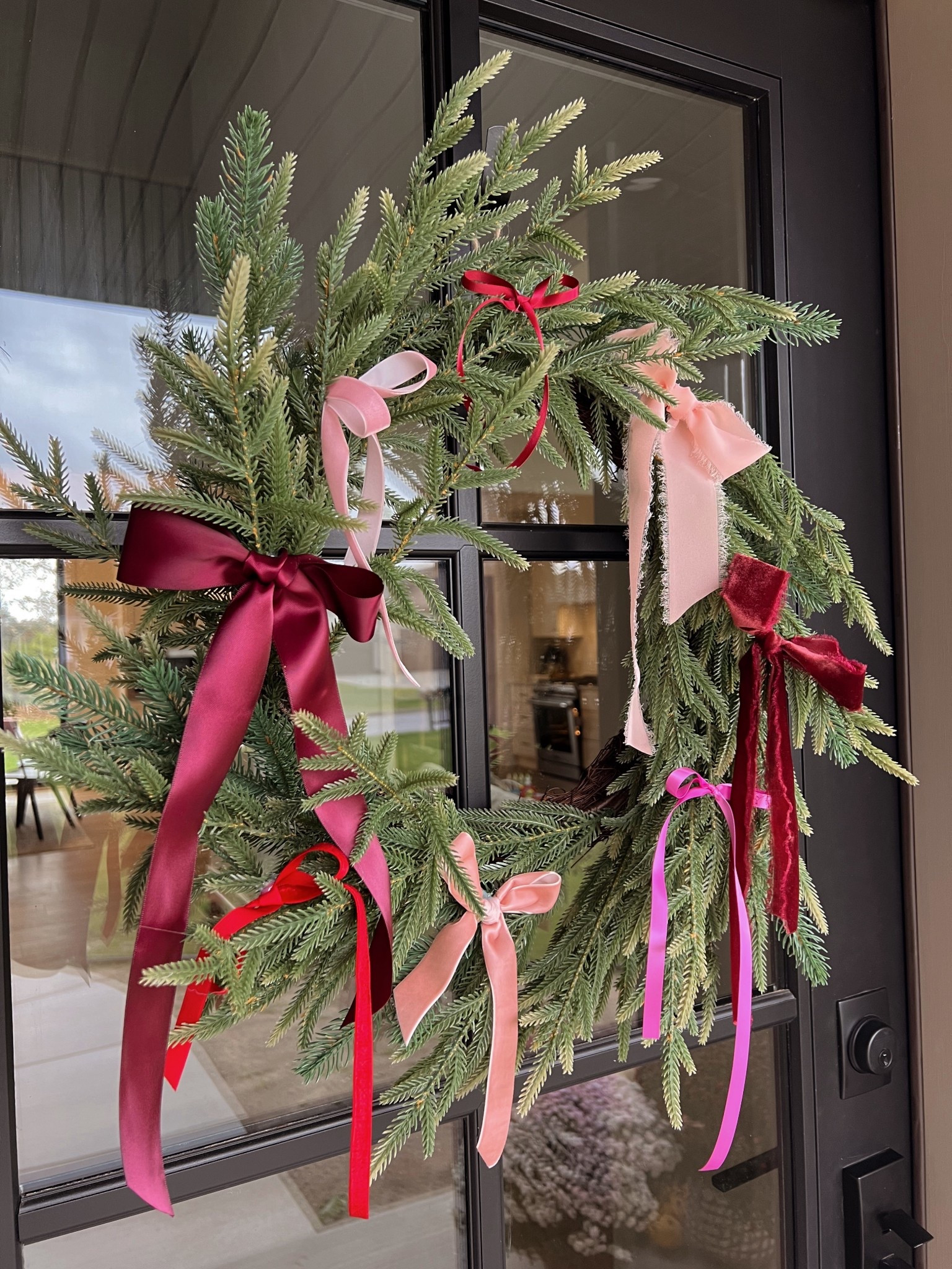 Norfolk pine wreath with a little diy. It only took me 10 minutes and some ribbon to completely transform this wreath to make it feel more Christmassy!🎄

#LTKSeasonal #LTKHoliday