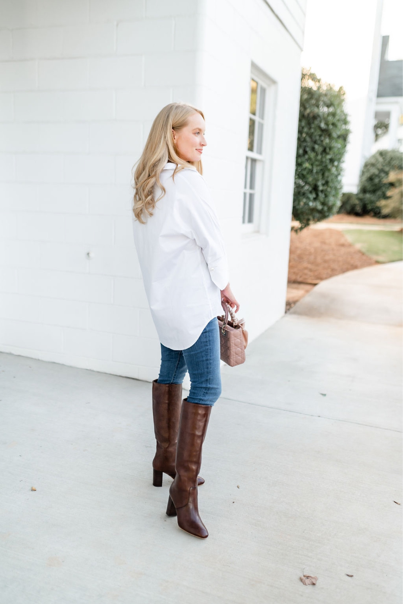 This classic white pullover shirt is legging friendly. Pair it with skinny jeans or leggings and knee-high leather boots. Finish the look with a Small lady Dior bag. 

#LTKSeasonal #LTKitbag #LTKstyletip