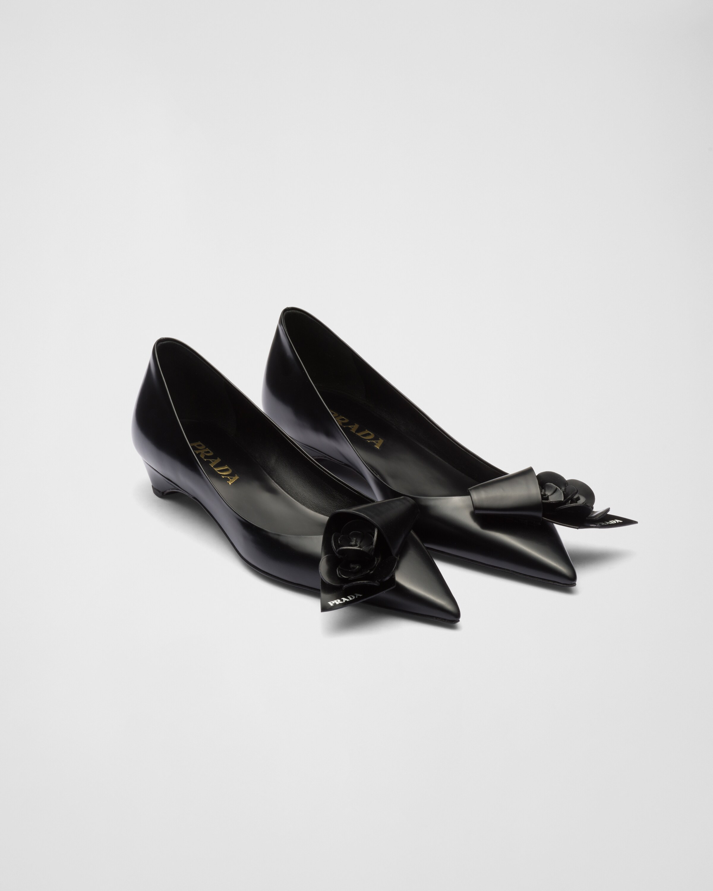 Brushed leather pumps with floral appliqués | Prada Spa US