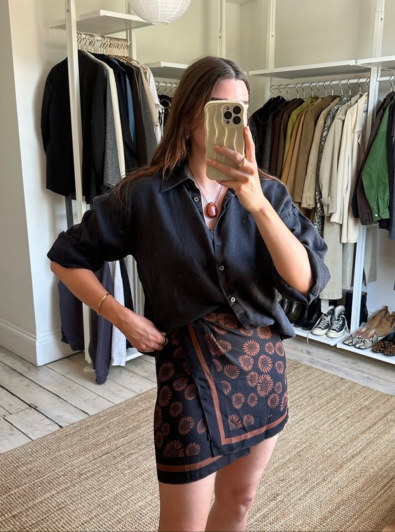 A black linen shirt paired with a pareo-style skirt, elevated with a statement necklace. A perfect holiday evening look.


#LTKsummer #LTKstyletip