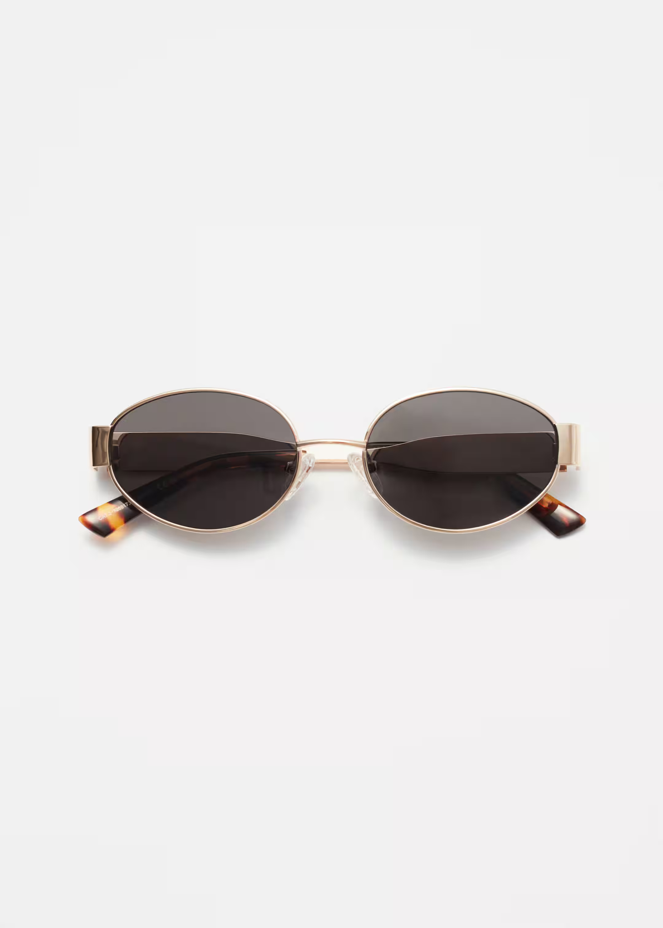 These sunglasses have timeless oval frames. Fitted with dark lenses, they're made from gleaming g... | & Other Stories - US