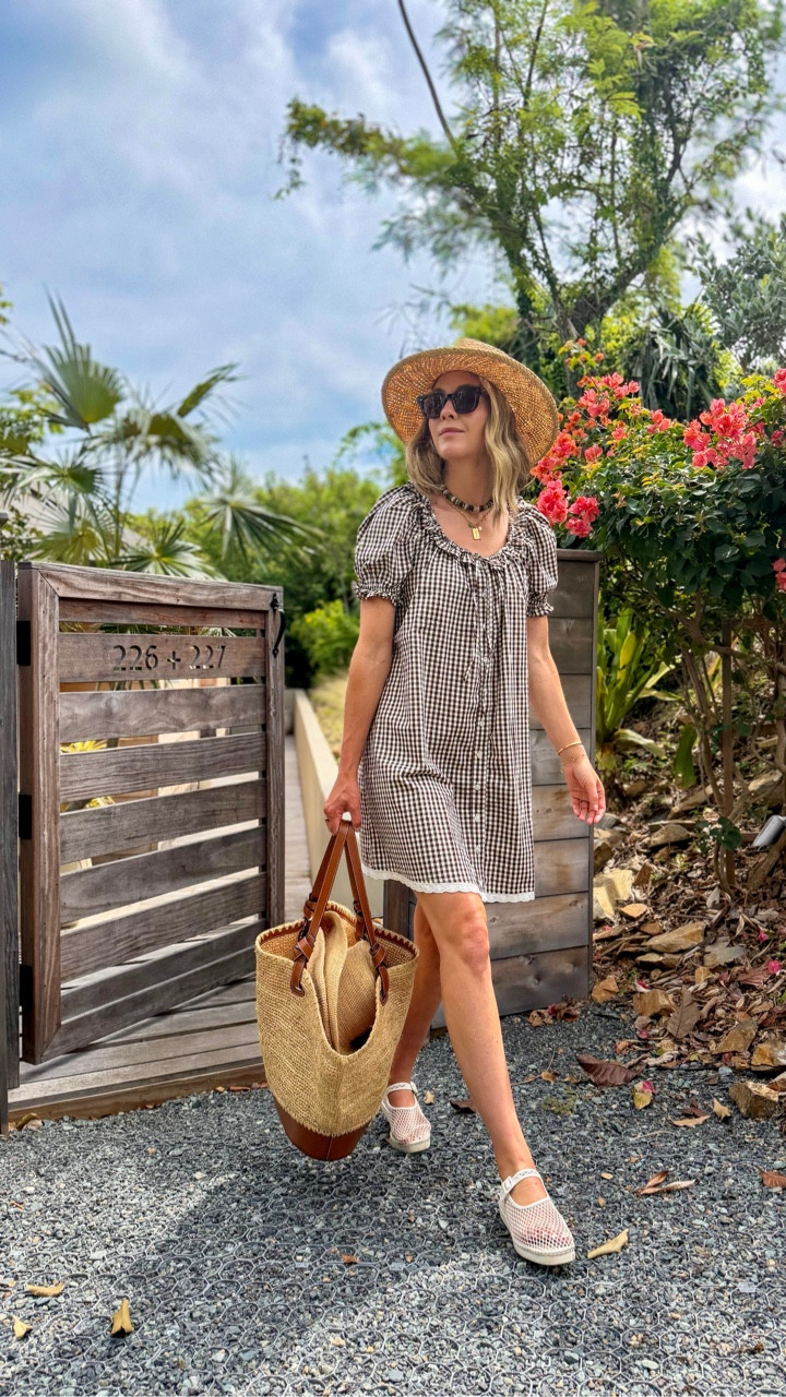 this chocolate gingham dress (under $150!) is one of those pieces that feels put together with zero effort, and I love how lightweight it is for warm travel days. I layered my go-to $40 sweater over my shoulders for chilly trains/flights, and these mesh mary janes are so comfortable… perfect for long days on your feet but still feel a little elevated.

finished it off with a few favorites I always reach for while traveling… my jennifer behr earrings, chimi sunglasses, lack of color fedora, my sézane basket bag, and my hart carpe diem necklace 🤍

Wearing size xs dress, use code charli15 to save!

#LTKSeasonal #LTKootd #LTKTravel