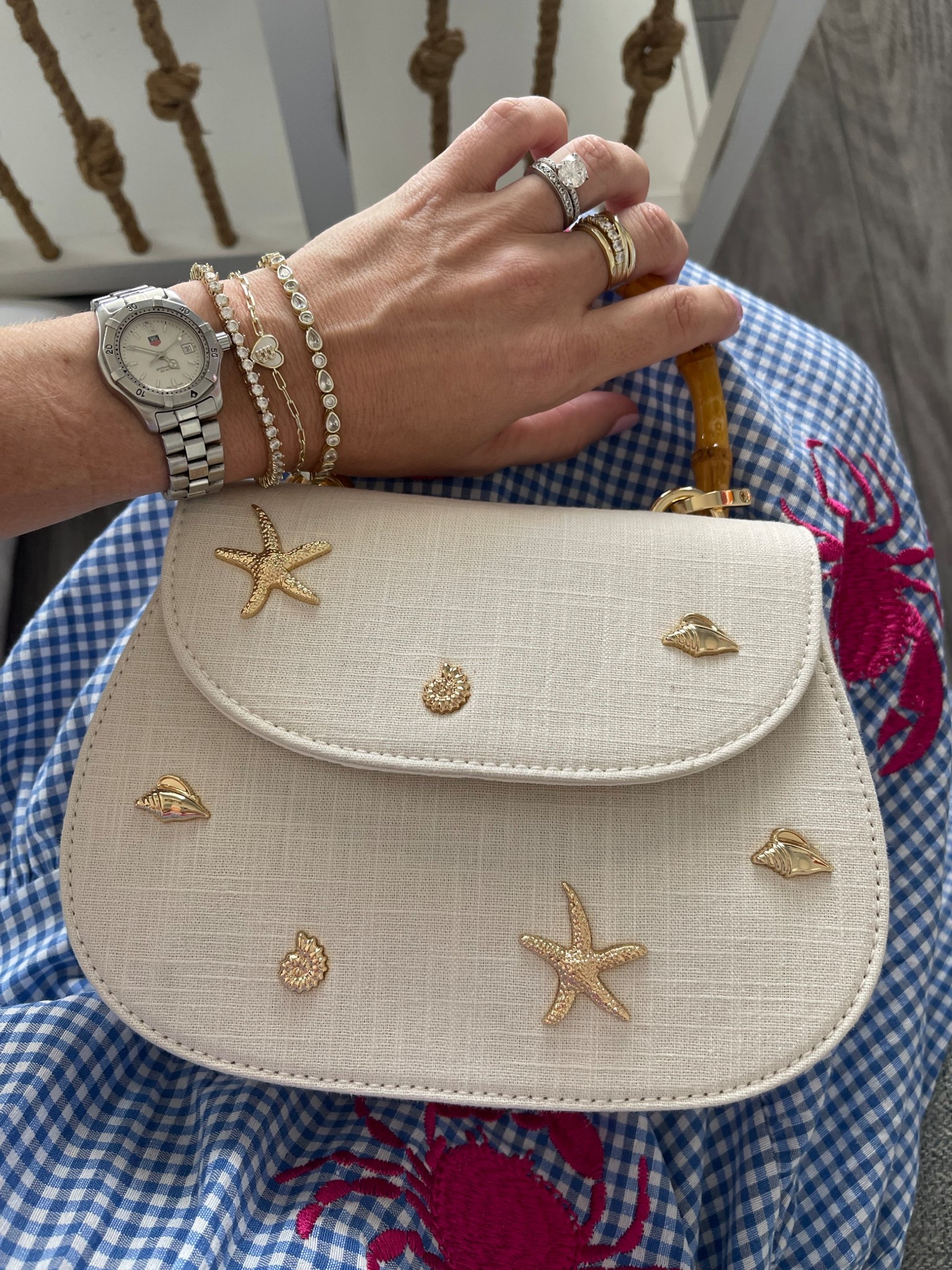 🦀 Dress is size XS | Headband & bag are Amazon finds 💙🤍

Nothing says coastal summer like a breezy blue gingham maxi with embroidered pink crabs 🦀💗 This tiered dress is light, flowy, and full of personality—perfect for seaside strolls, summer parties, or a crab boil on the porch! 🐚🍉 I paired it with a classic ivory textured knot headband and a darling mini top-handle bag featuring gold sea-inspired embellishments 🌟🐚

✨ Accessories:
	•	Headband: textured ivory twist style 👑
	•	Bag: cream mini satchel with starfish & shell accents 👜
	•	Jewelry: coastal-inspired statement necklace + Melinda Maria favorites (use code PREPPYREBEL for 10% off!) 💎🌊

📸 A perfect preppy pick for beach towns, nautical getaways, or backyard barbecues with a touch of whimsy 💙


#LTKItBag #LTKFindsUnder50 #LTKSaleAlert