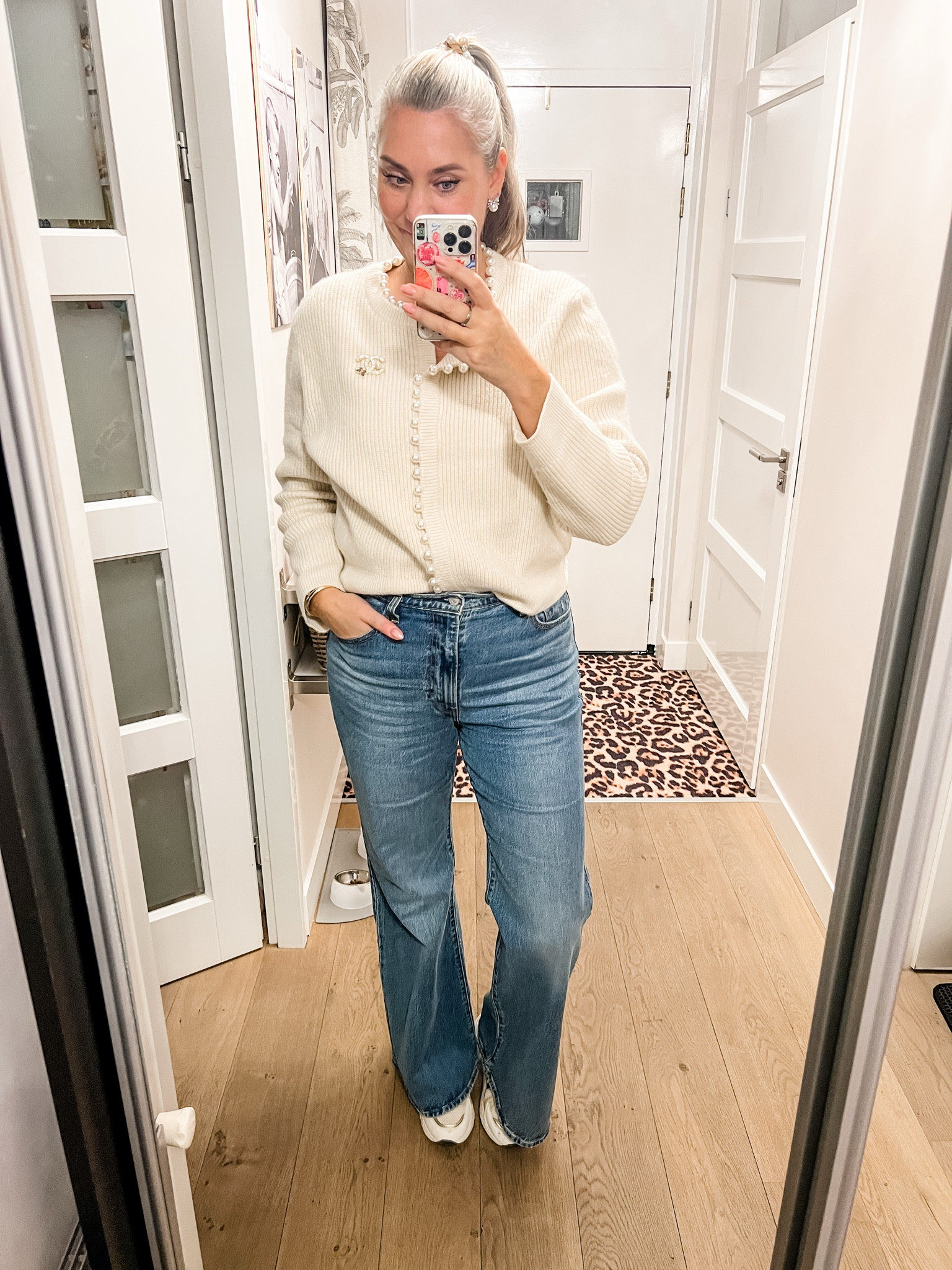 Ootd - Monday. A beige heavy knit cardigan with pearls all round the trim over a beige low cut short sleeve bodysuit paired with flared Levi’s jeans, beige chunky sneakers (old), pearl and bow earrings and pearly hair elastic. 



#LTKeurope #LTKworkwear #LTKwinter