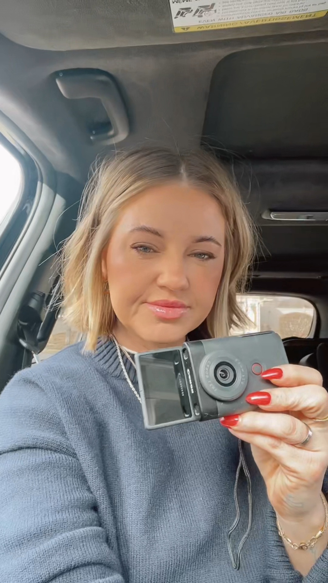 the camera and the crewneck. 