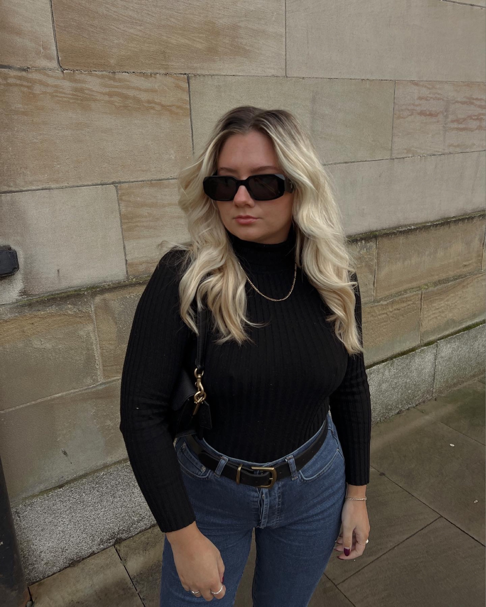black roll neck ribbed jumper, black & gold buckle leather belt, prada sunglasses and dark blue denim jeans 

#LTKsalealert #LTKstyletip #LTKeurope