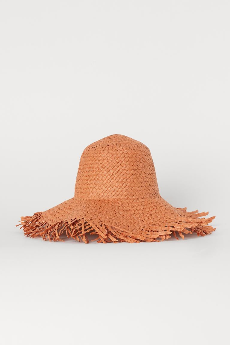 Hand-made hat in braided paper straw with fringed edges.CompositionPaper straw 100%Art. No.078095... | H&M (US + CA)