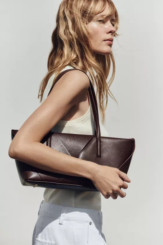 Elongated woven bag. Shoulder strap. Interior zip pocket. Zip closure.Height x Length x Width: 6.... | Zara US