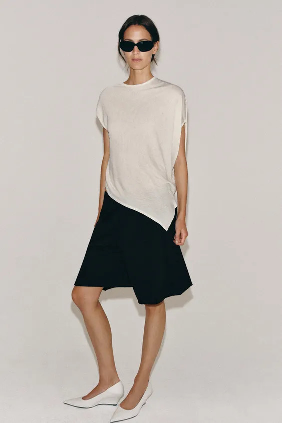Flowy round neck top with asymmetric sleeves and hem. | Zara UK