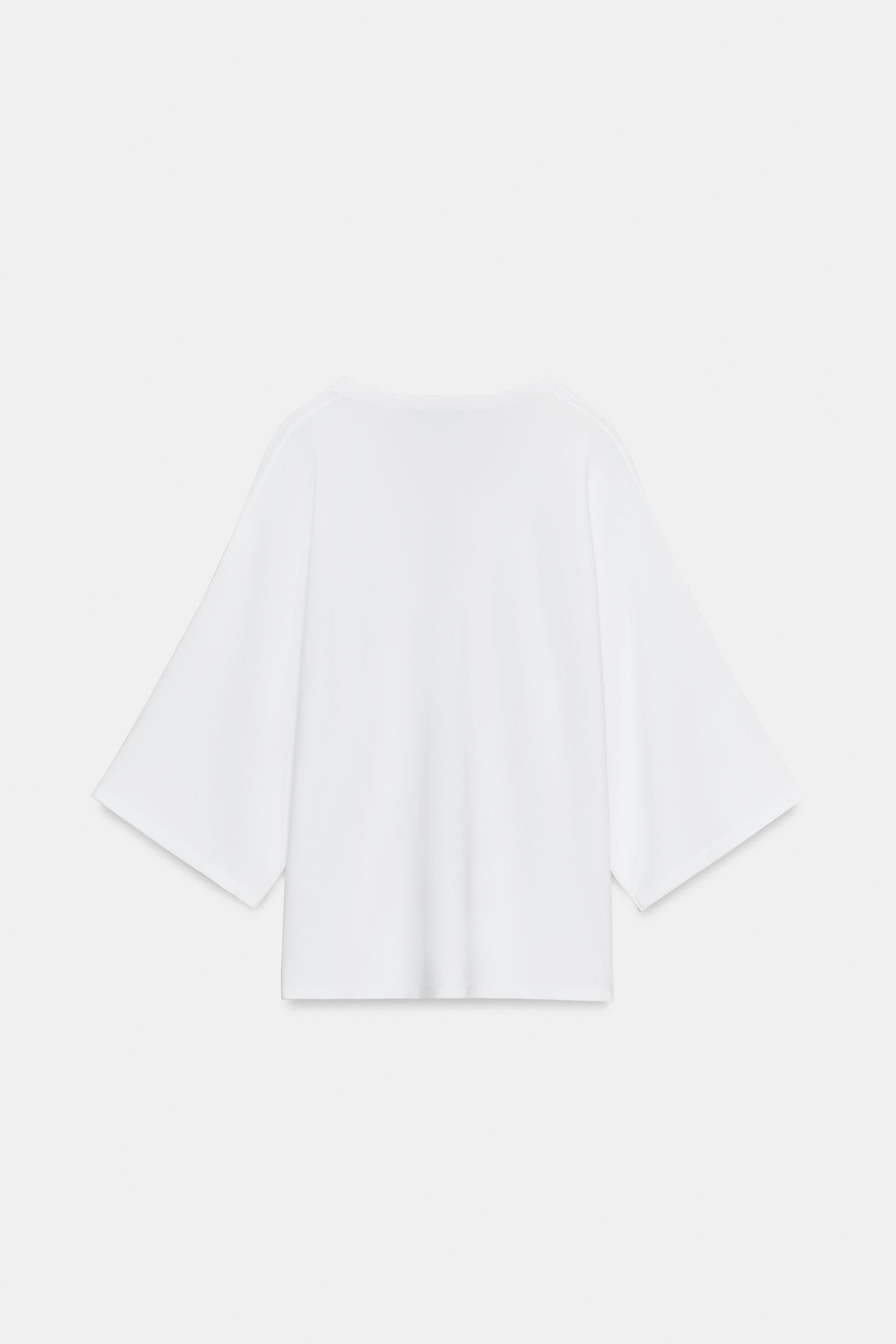Flowy plain knit jumper with V-neck and short sleeves. | Zara US