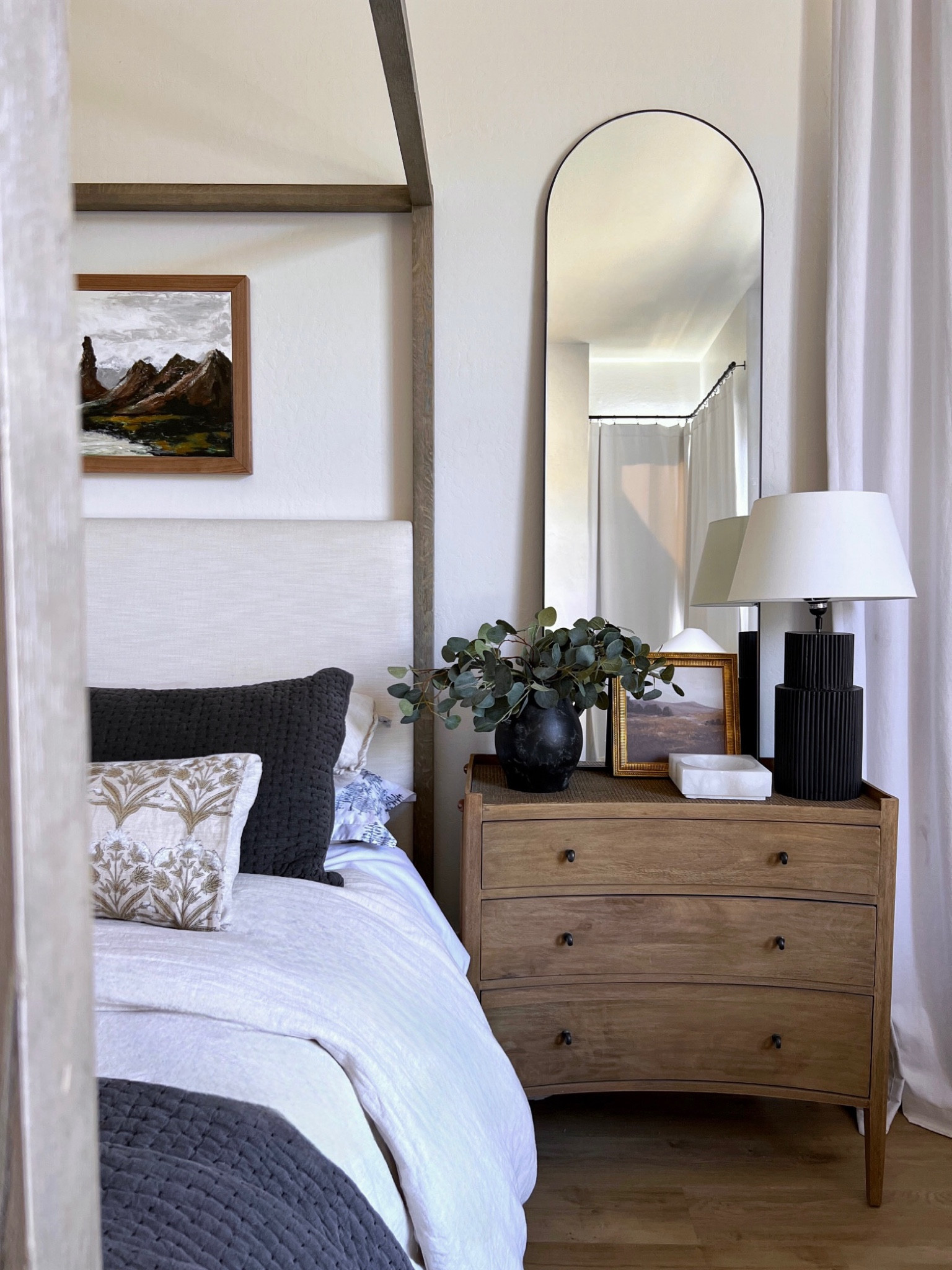 Bedroom decor 
Arched mirror
Black fluted lamp 
Marble catchall 
Black pottery 
Artwork 
Bedding 
Nightstand 

#LTKunder50 #LTKhome #LTKunder100