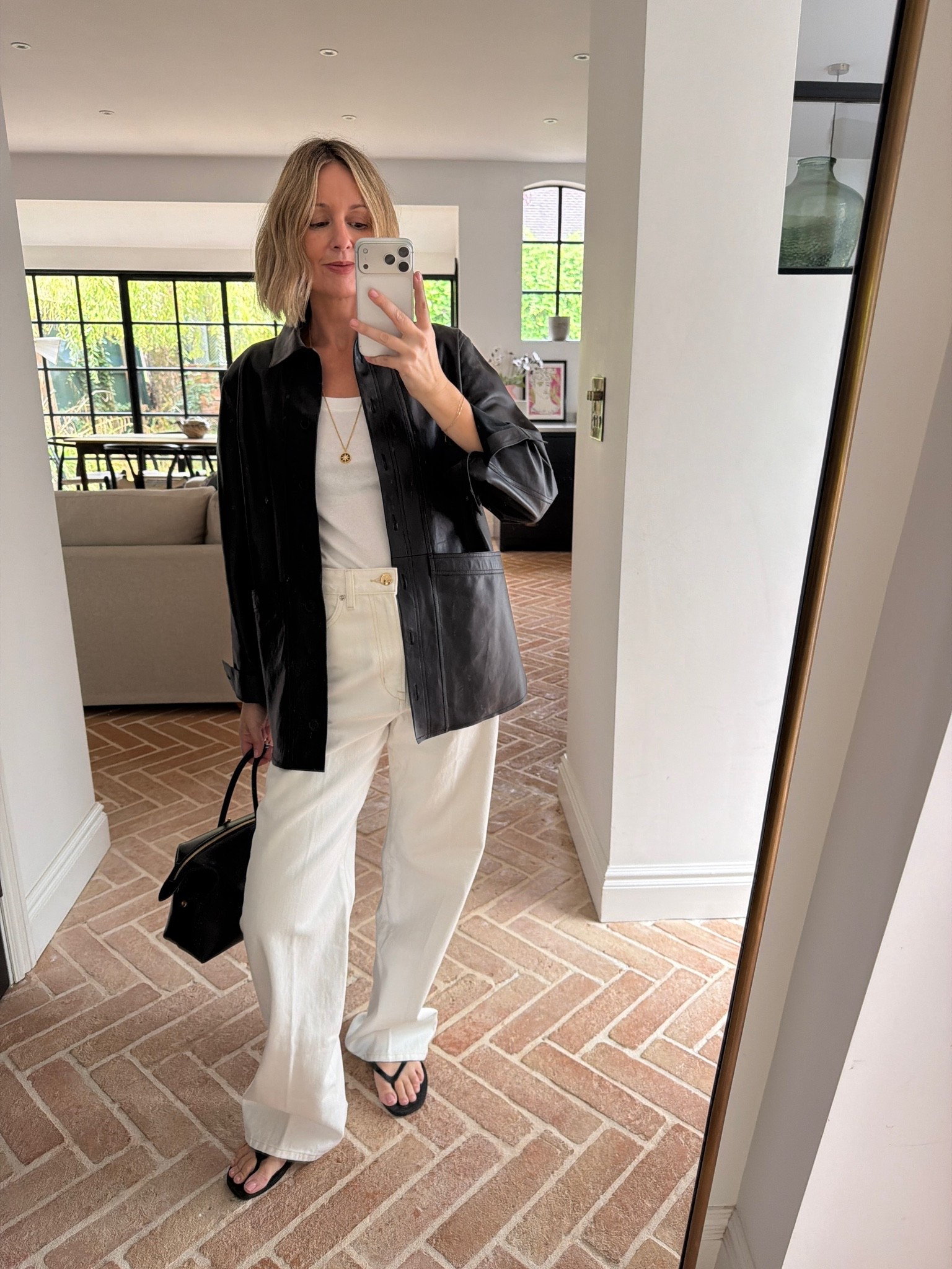 black leather shirt jacket, black leather shacket, white ribbed tank top, ivory wide leg jeans, cream denim, black leather handbag, structured tote, black flip flops, gold pendant necklace, layered gold jewelry, transitional dressing, elevated basics, quiet luxury, effortless chic, ltkstyletip, ltkseasonal, ltkfindsunder100, outfit inspo, capsule wardrobe essentials

#LTKdatenight #LTKluxury #LTKjeans