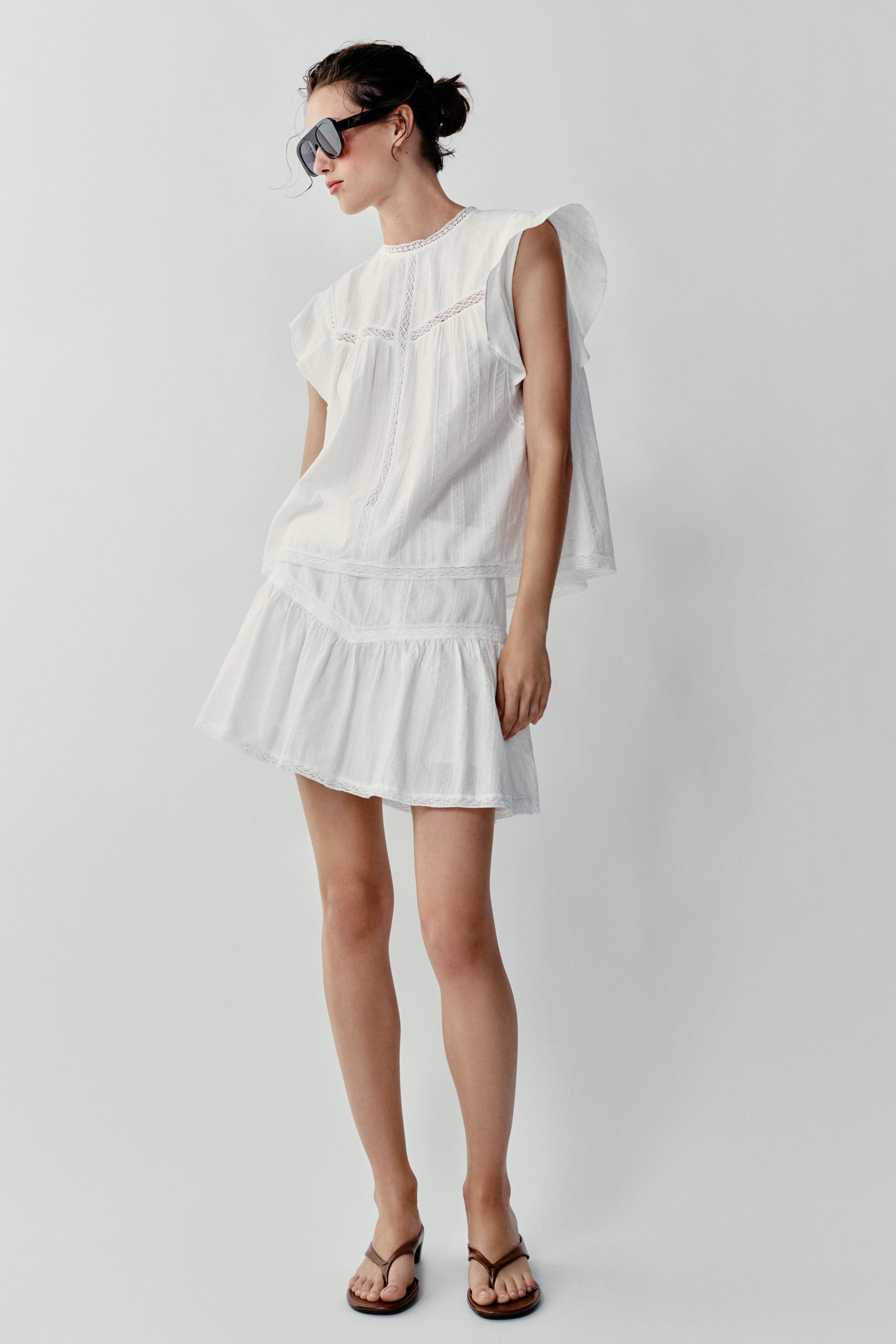 Round neck sleeveless top with ruffle. Finished with tonal ladder trim detail. Back opening with ... | Zara US