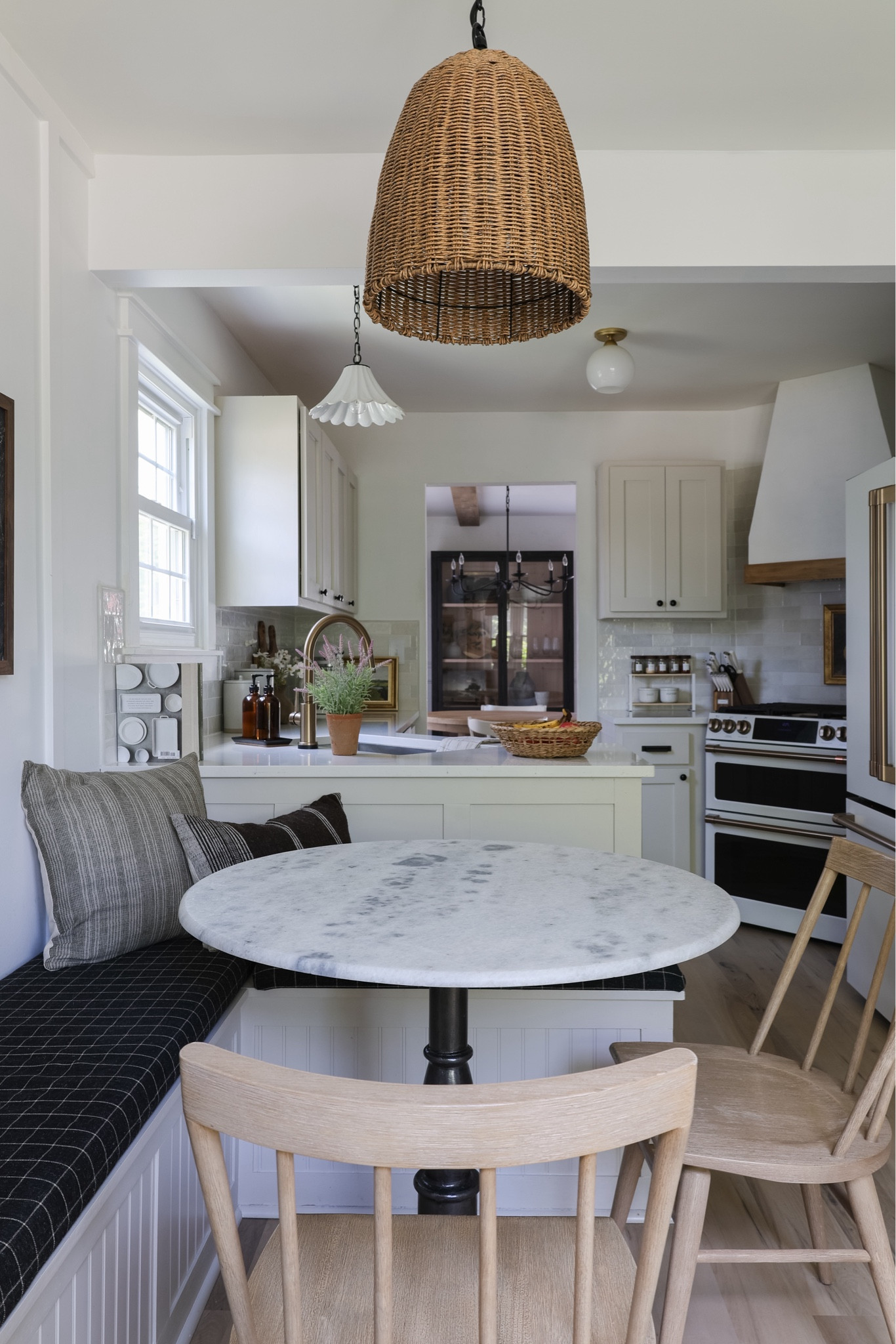 Breakfast nook, kitchen decor, small dining space, round marble table, marble bistro table, wood chairs, spindle chairs, woven pendant, ceramic pendant, scalloped pendant light, countertop decor, pottery barn decor, pottery barn furniture, cafe appliances, Wayfair, home goods 

#LTKHome