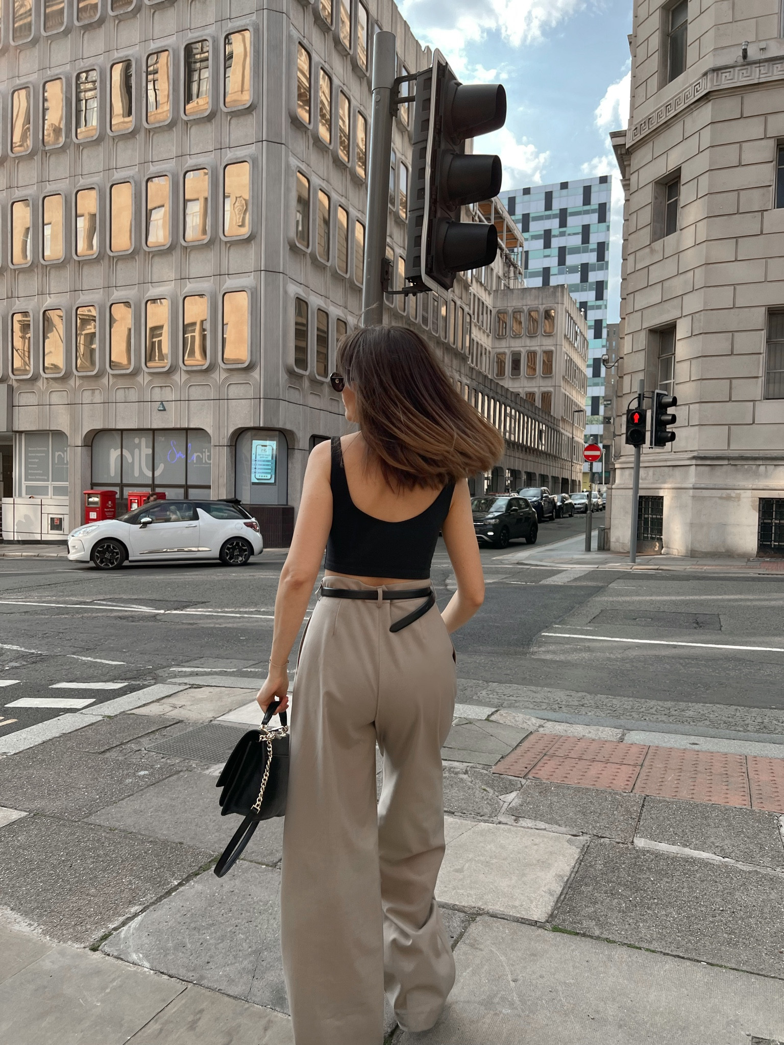 Black halter neck crop top, nude beige formal trousers, black crossbody bag, black belt

#LTKeurope #LTKSeasonal #LTKstyletip
