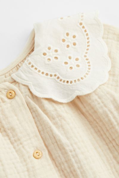 Conscious choice  New ArrivalBaby Exclusive. Romper suit in airy, woven cotton fabric. Rounded, s... | H&M (US + CA)